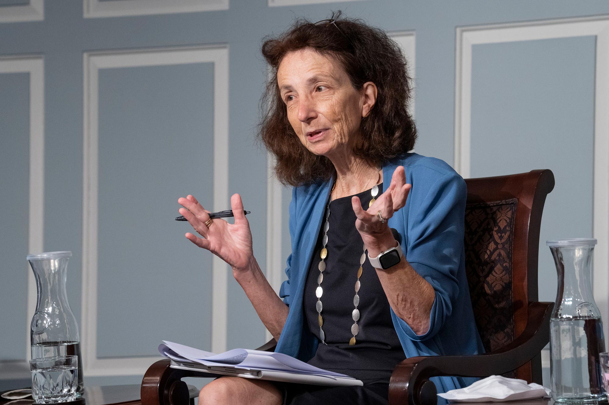 Naomi Cahn gestures with open hands while talking