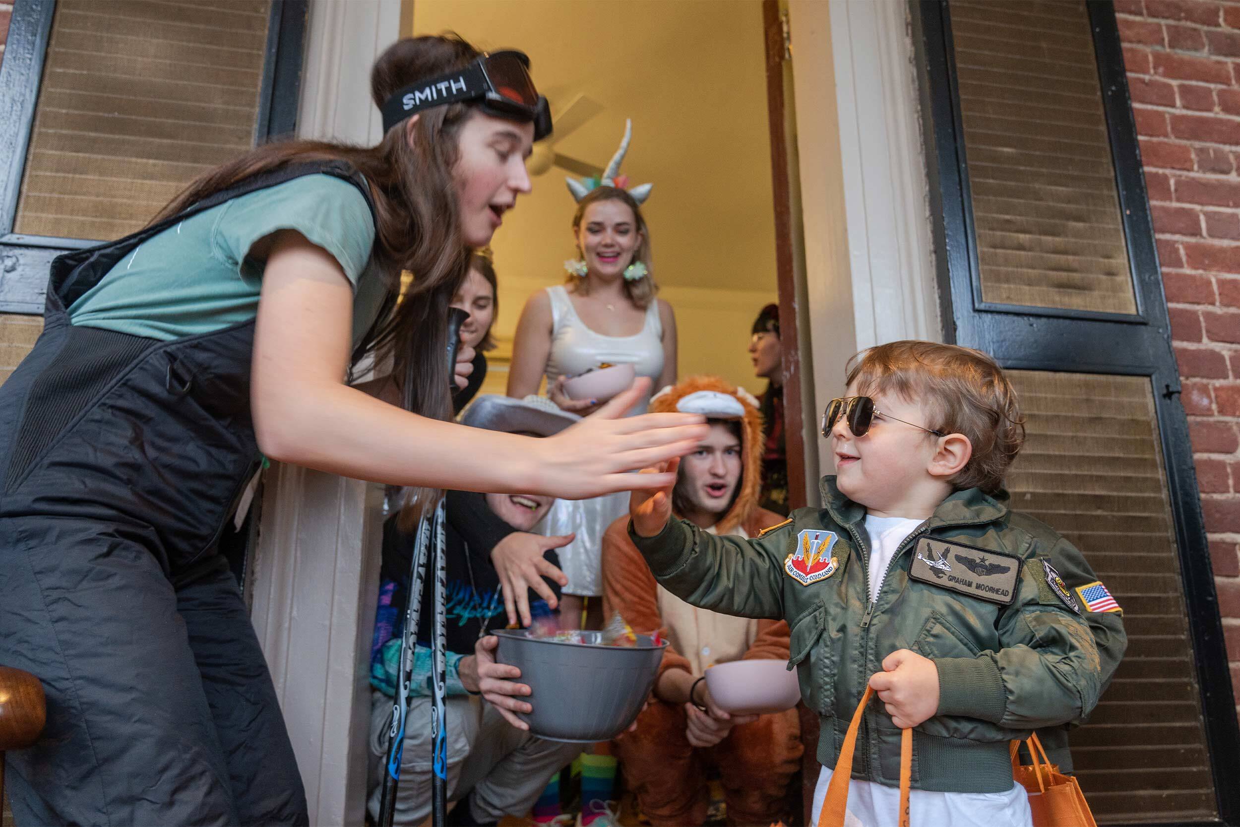 Small Maverick giving a high five to a college student