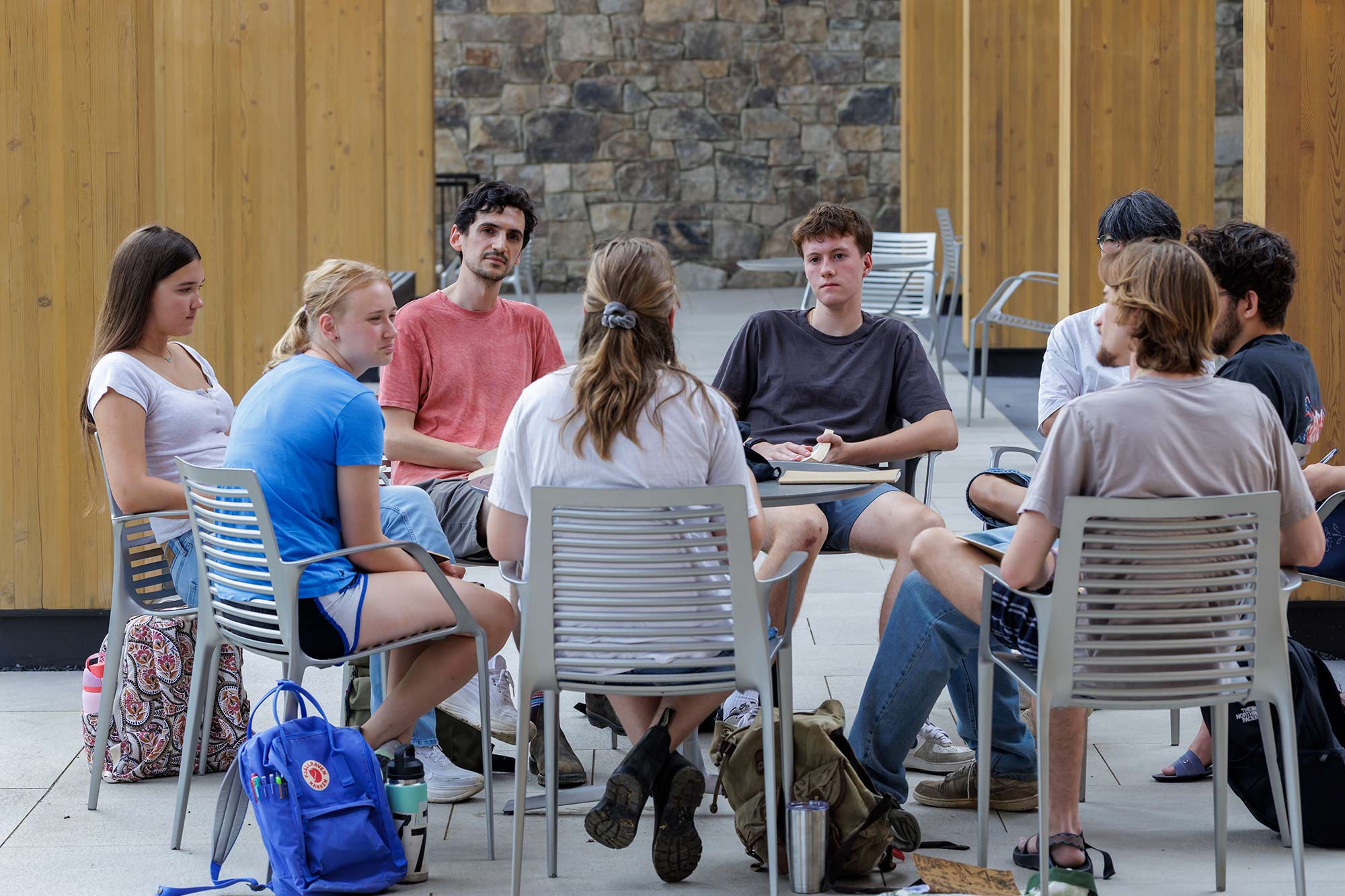 Group of students in a circle discussing.
