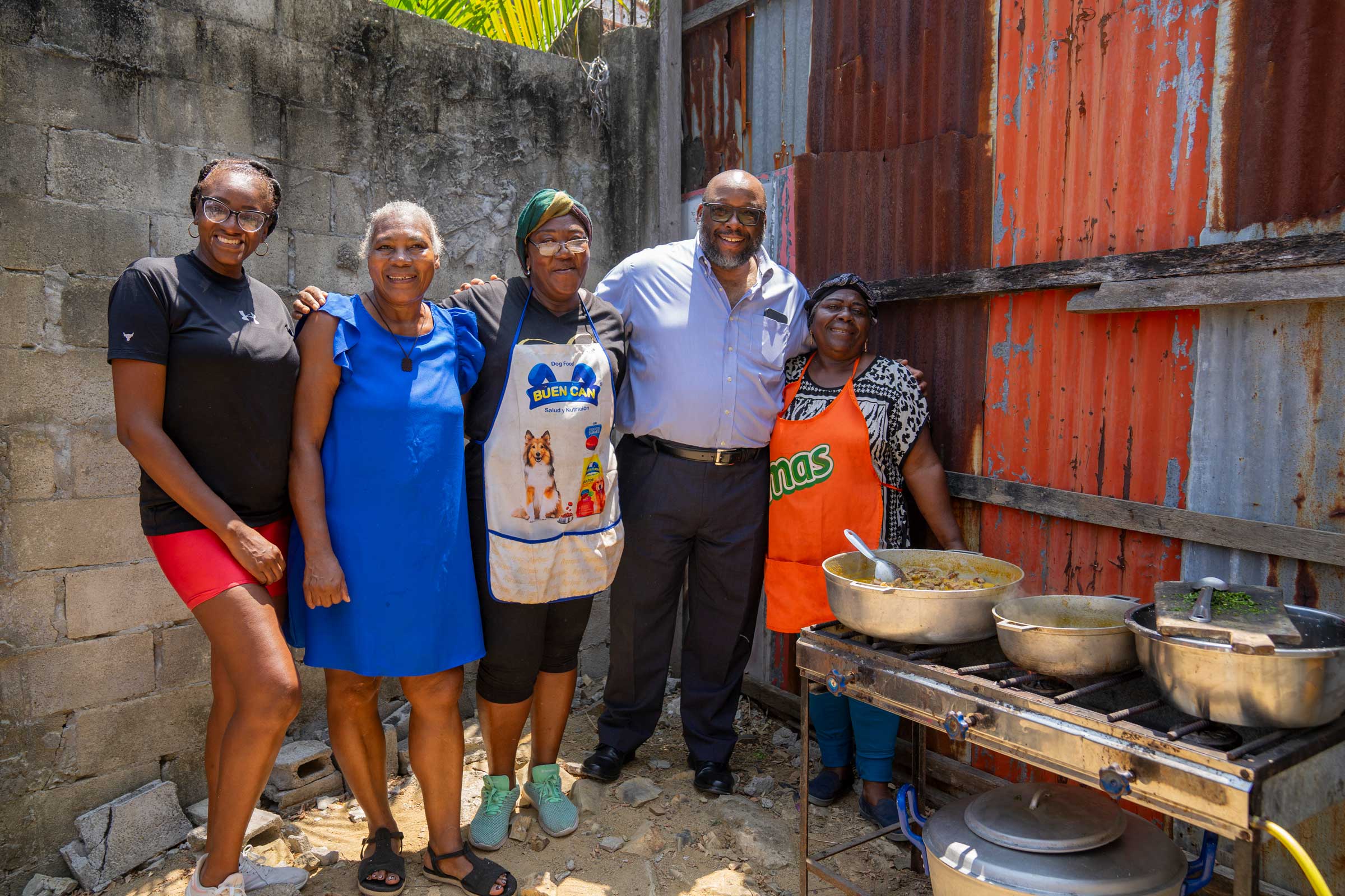 Art Brown posing at an outdoor cookout with four Ecuadorians.