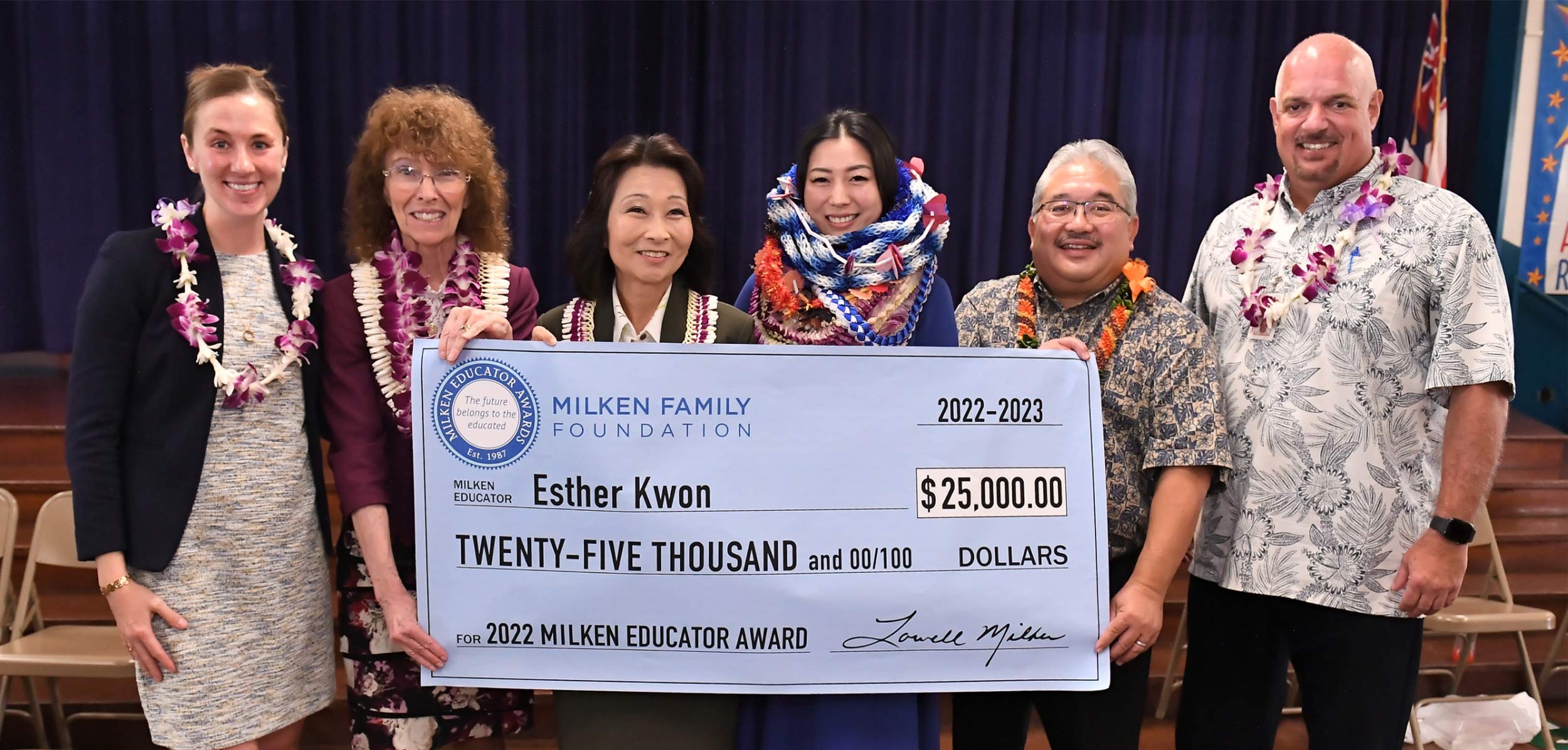 Kristin Walje, Jane Foley, Sylvia Luke, Esther Kwon, Keith Hayashi, and Robert Davis accepting a large check for $25,000