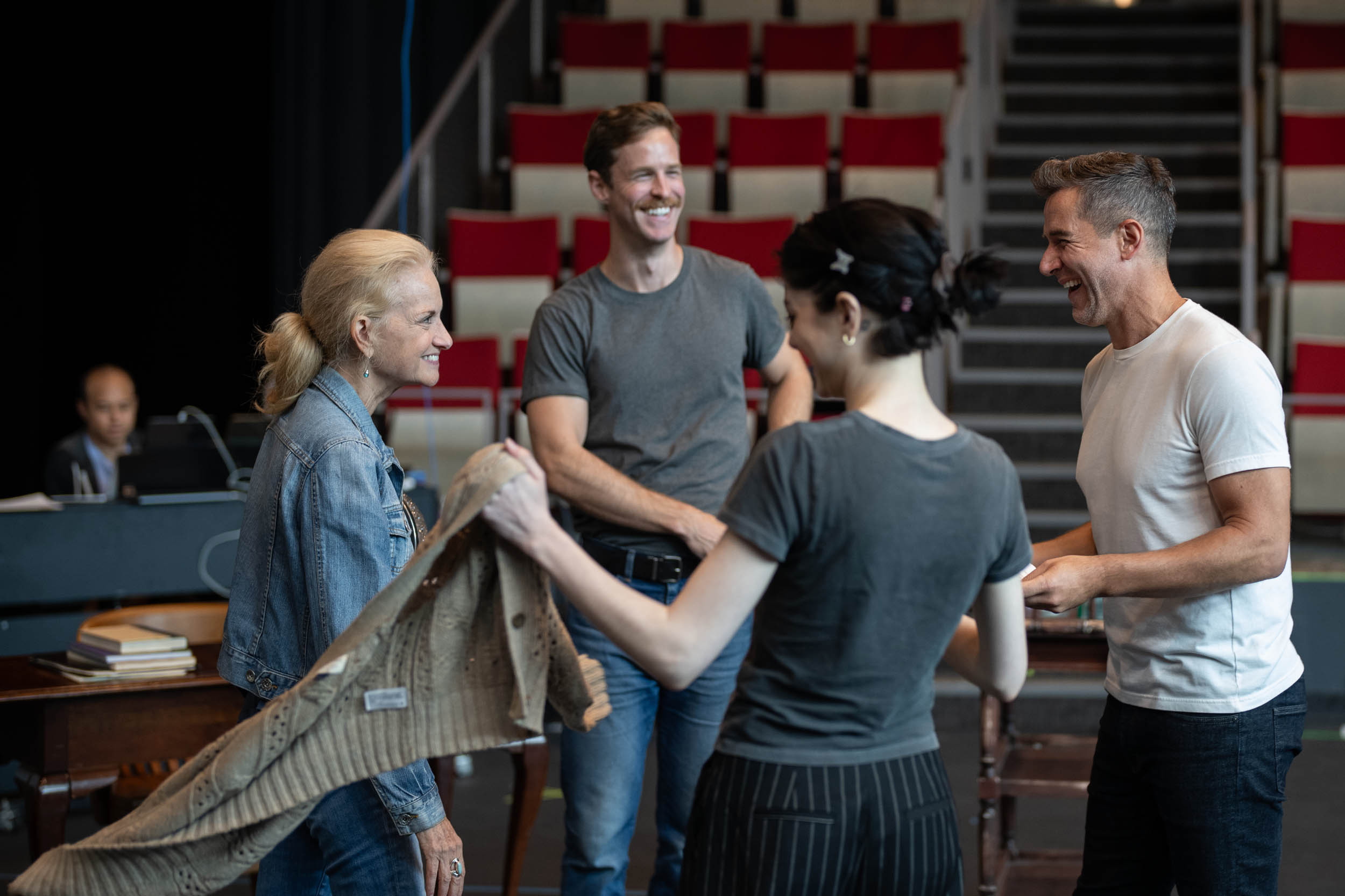 Group of actors gather and laugh together