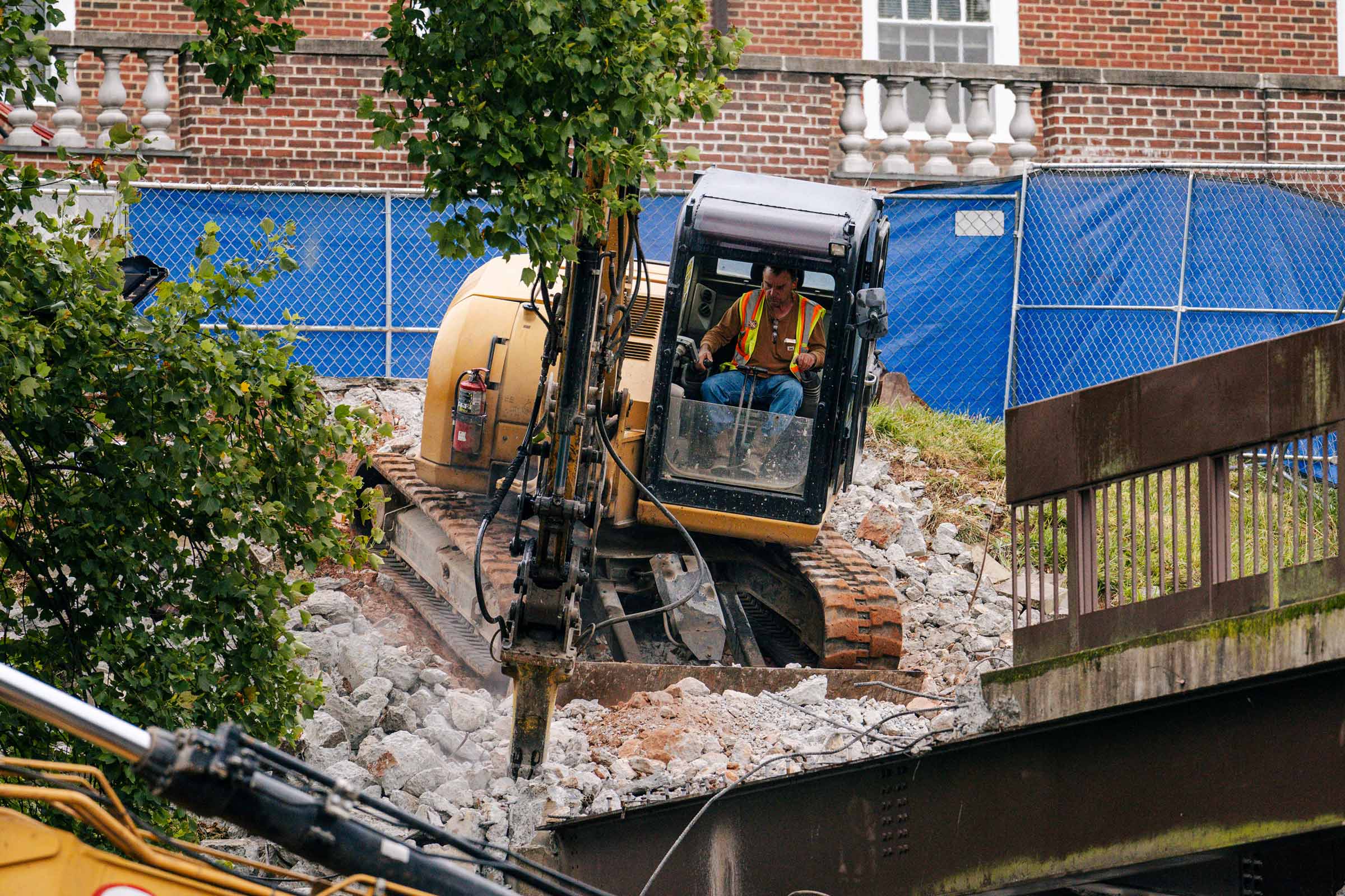 Construction worker using jackhammers removing rock.