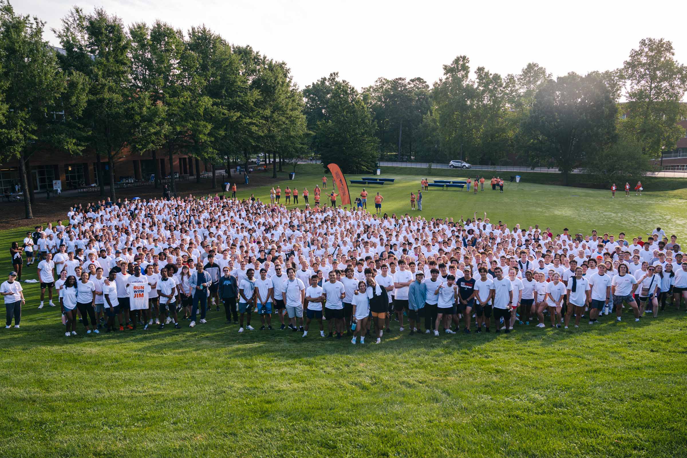 The largest group of Run with Jim participants gather on a field