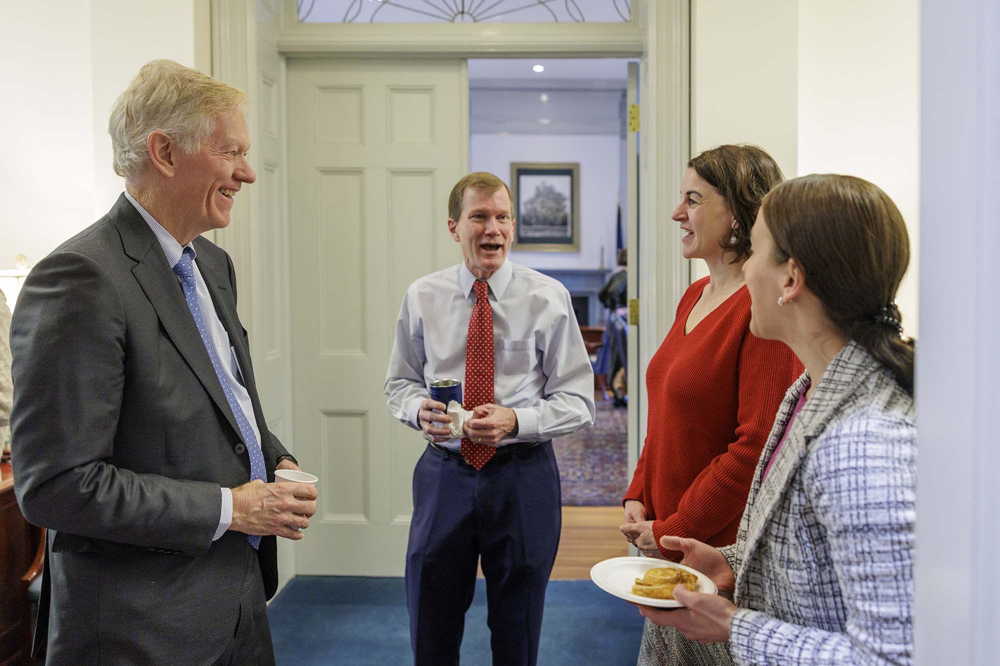 Beardsley talks with 3 people in the UVA Office of the President