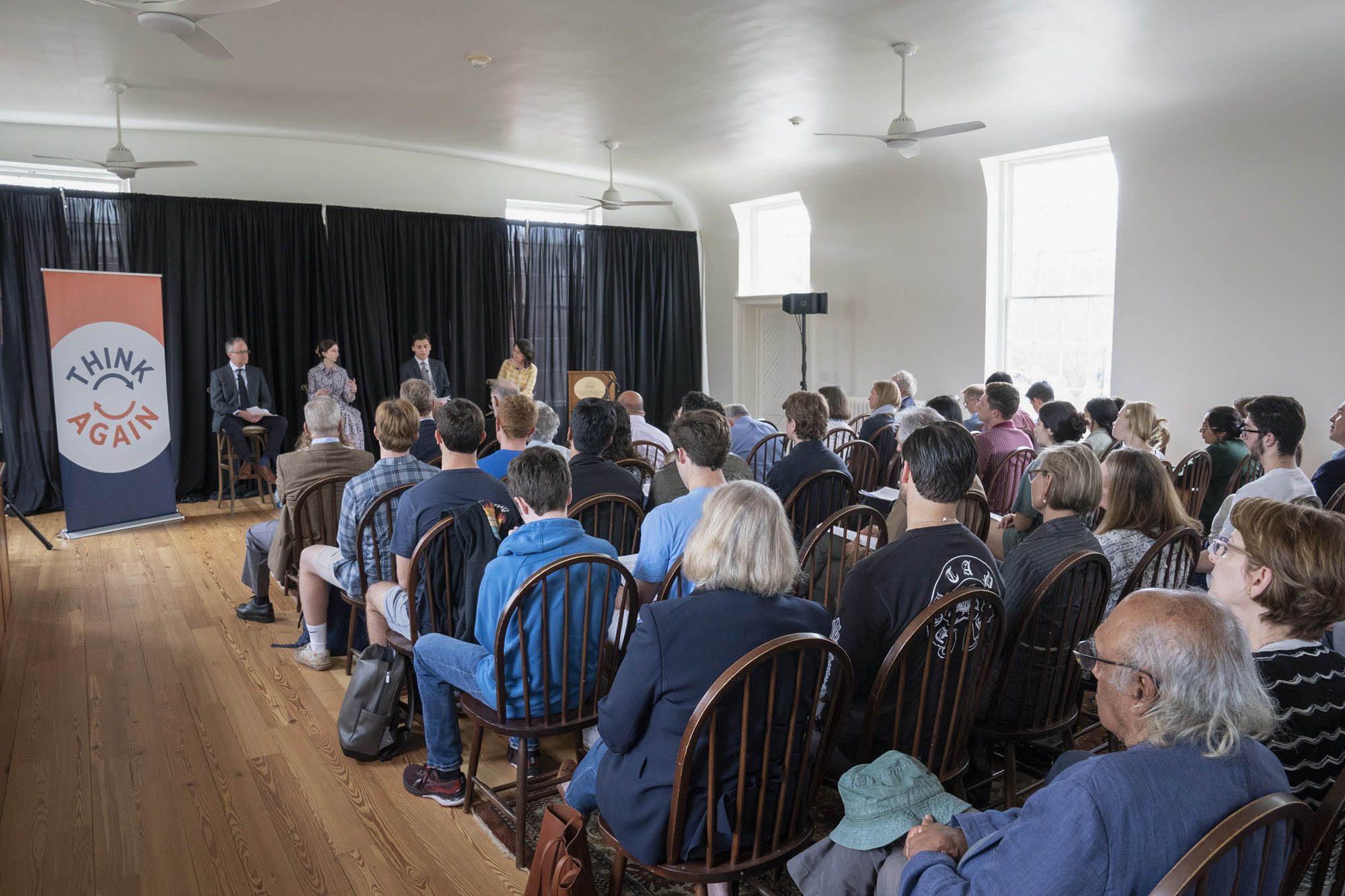 A crowd of people fill the seats during the Free Speech event