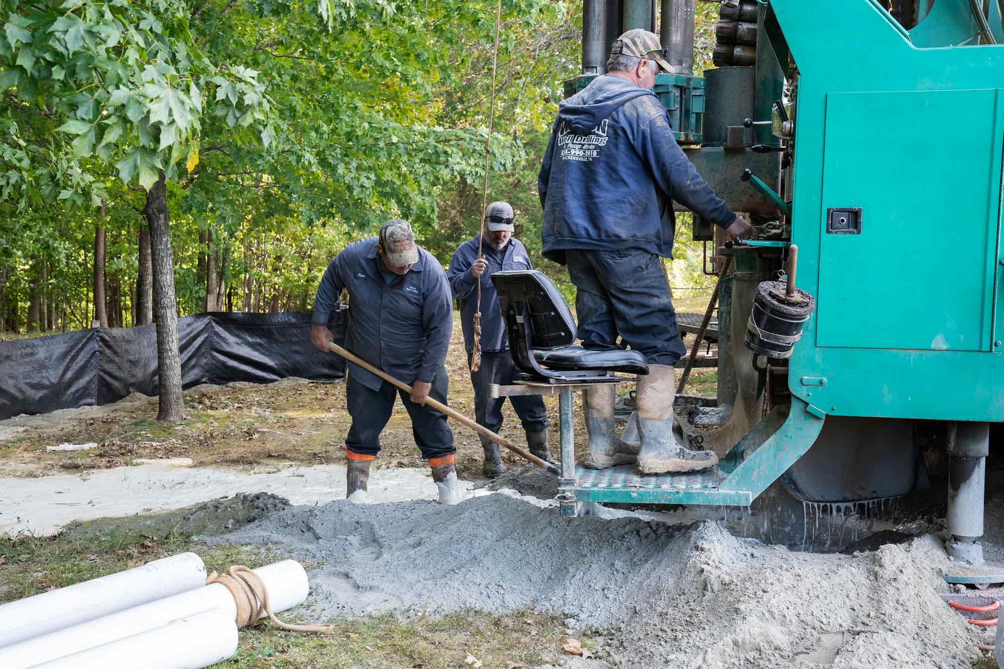 ] Ray Carpenter, Richard Hopkins and Jason Yowell work with equipment to drill a well