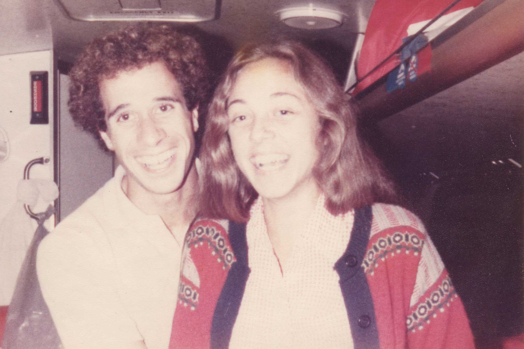 Old photo of Mark and Cynthia Lorenzoni inside a bus, smiling