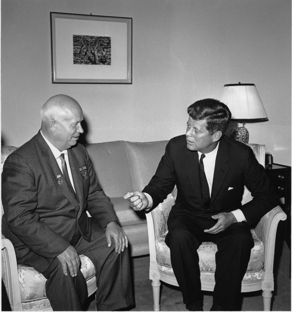 Nikita Khrushchev and John Kennedy, seated in a living room, chat