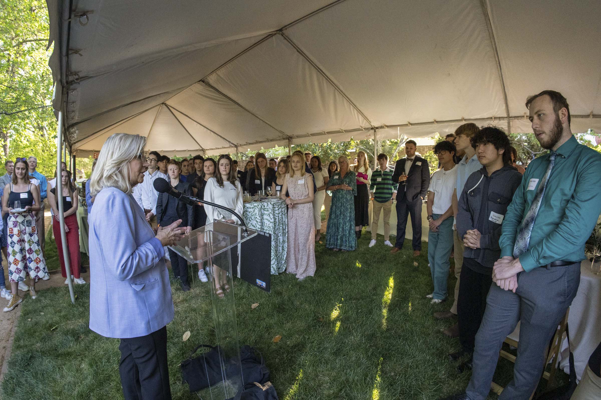 Liz Cheney addressing a reception of guests in the garden behing Pavilion IV