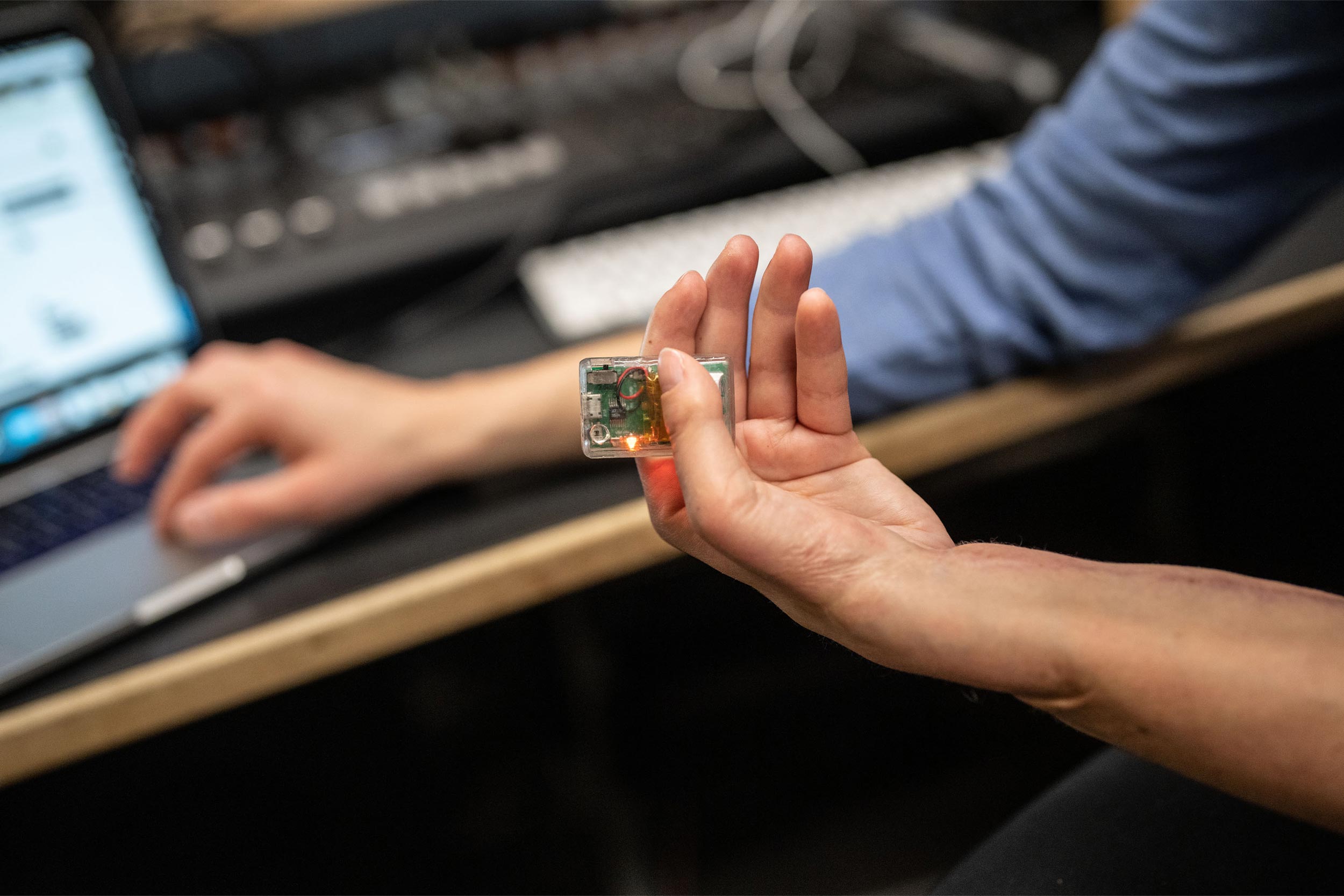 Close up of Joyce's hand holding a motion sensor