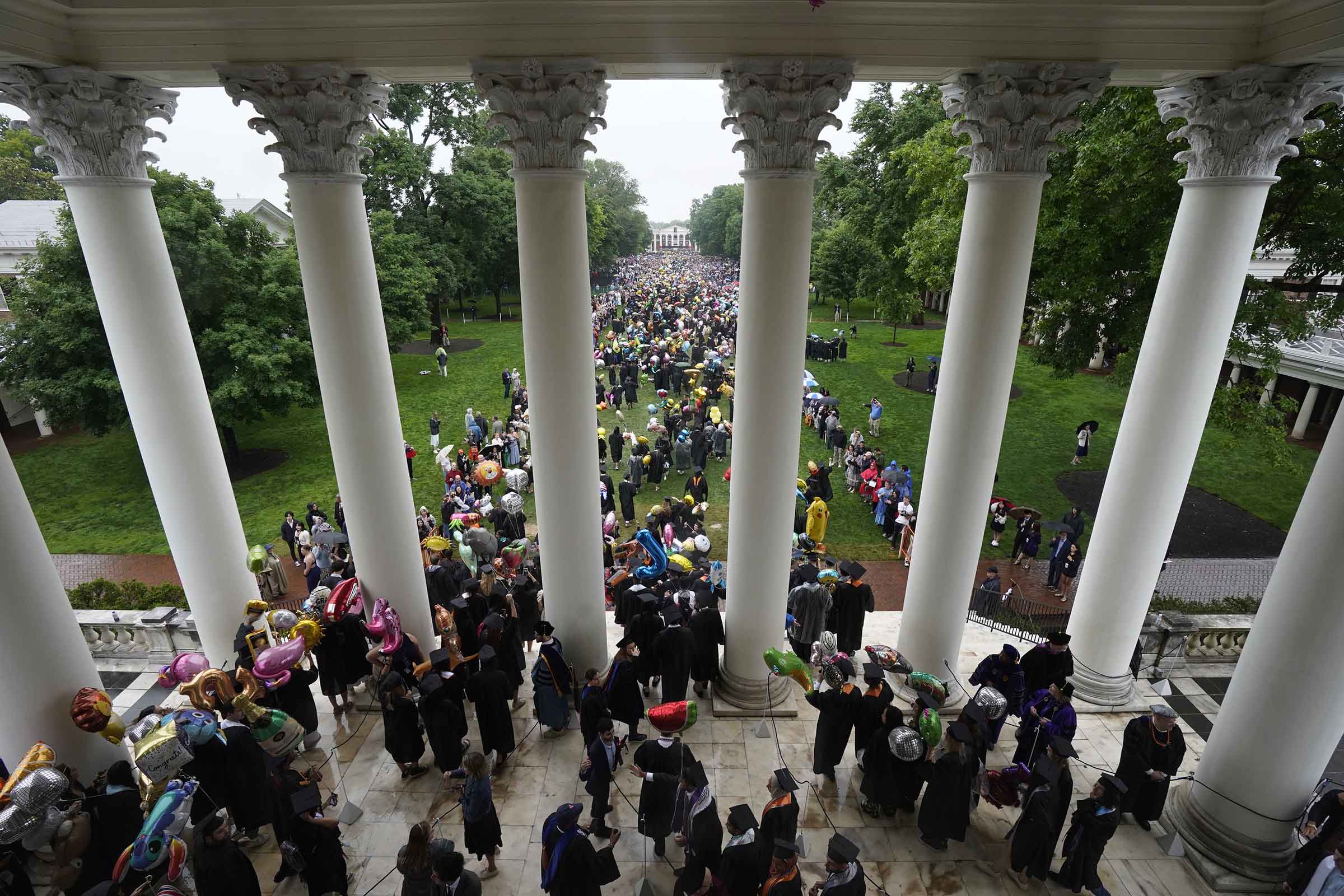 Graduating students coming down the stairs of the Rotunda onto the Lawn