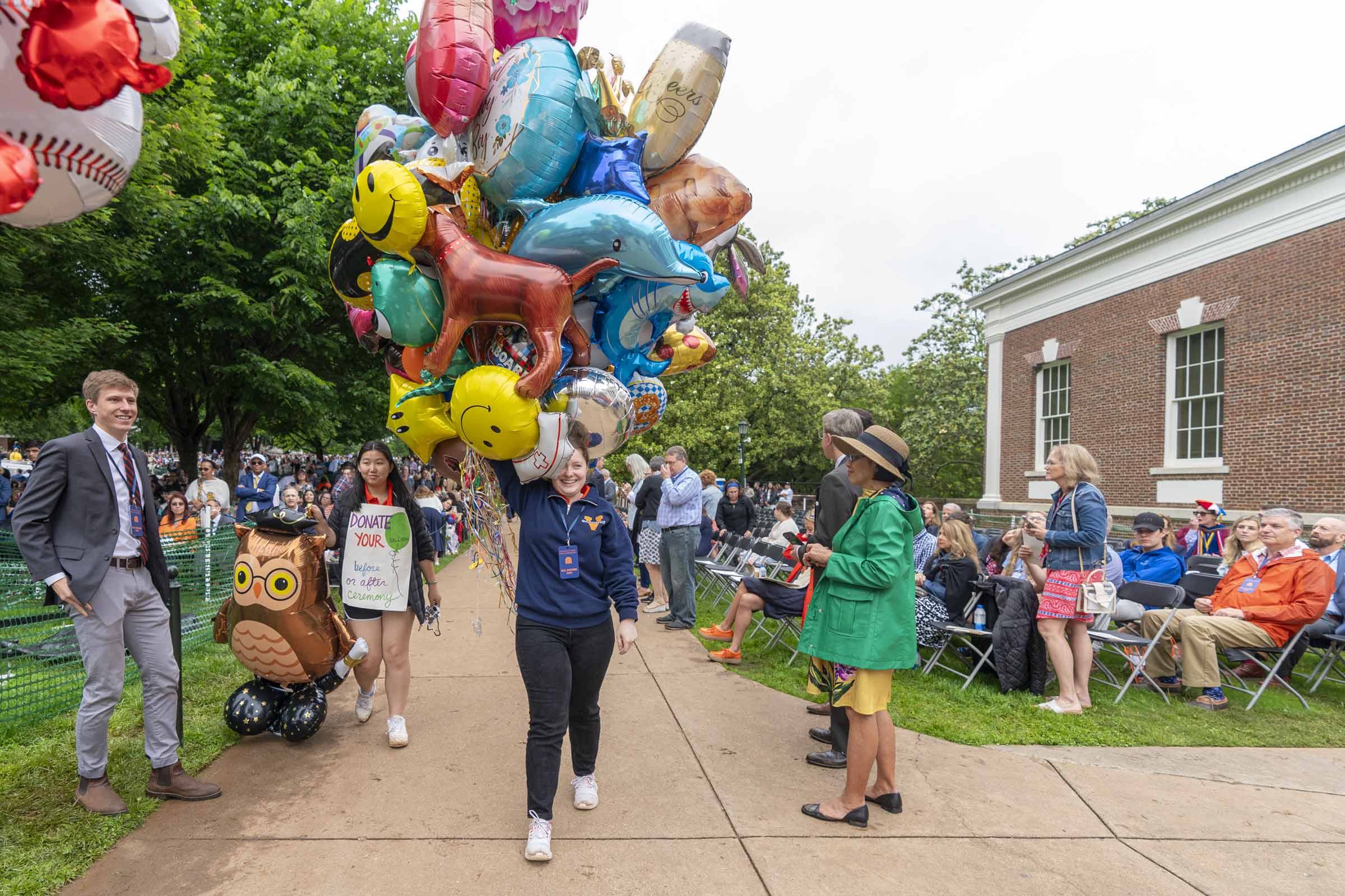 Faith Crosley, a rising-fourth year student, takes a haul of balloons into Old Cabell Hall. 