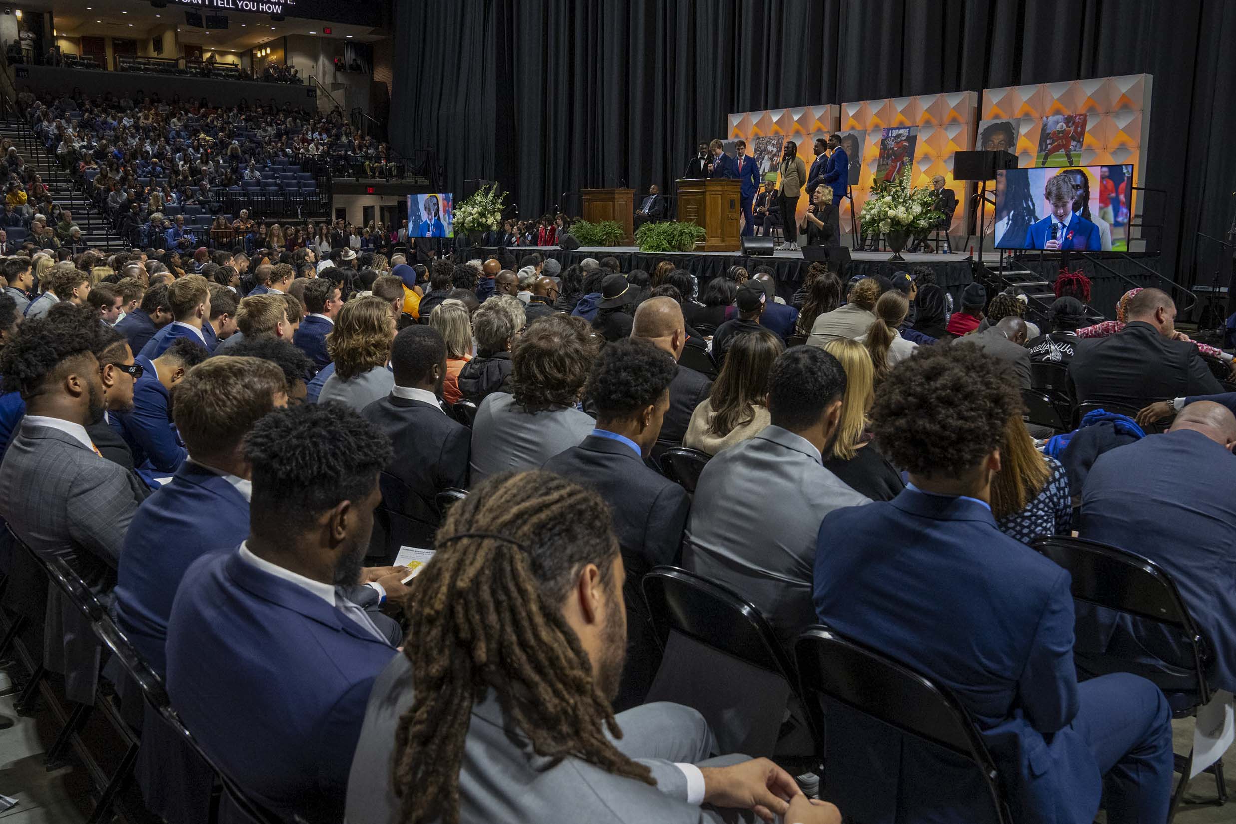 View of the football players from behind at the memorial service