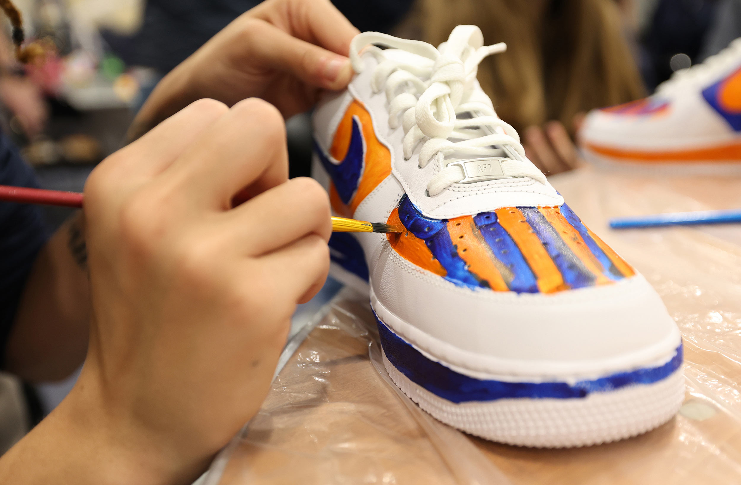 Blue and Orange stripe paint job on a shoe