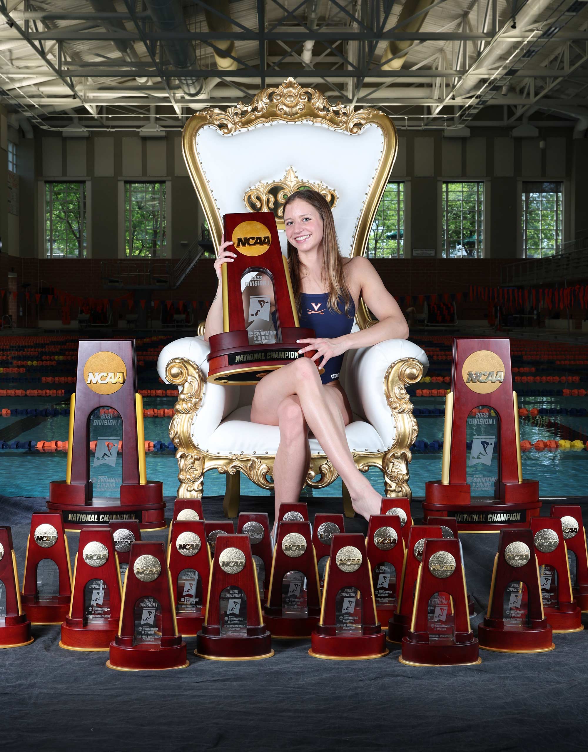 Kate Douglass surrounded by trophies