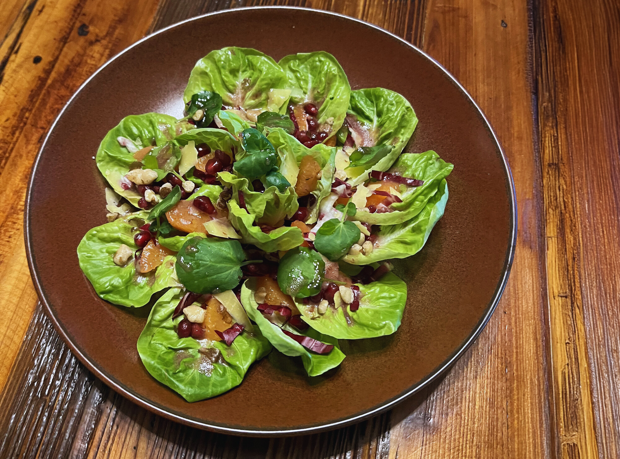 Winter greens with fruit, nuts and a vinegrette