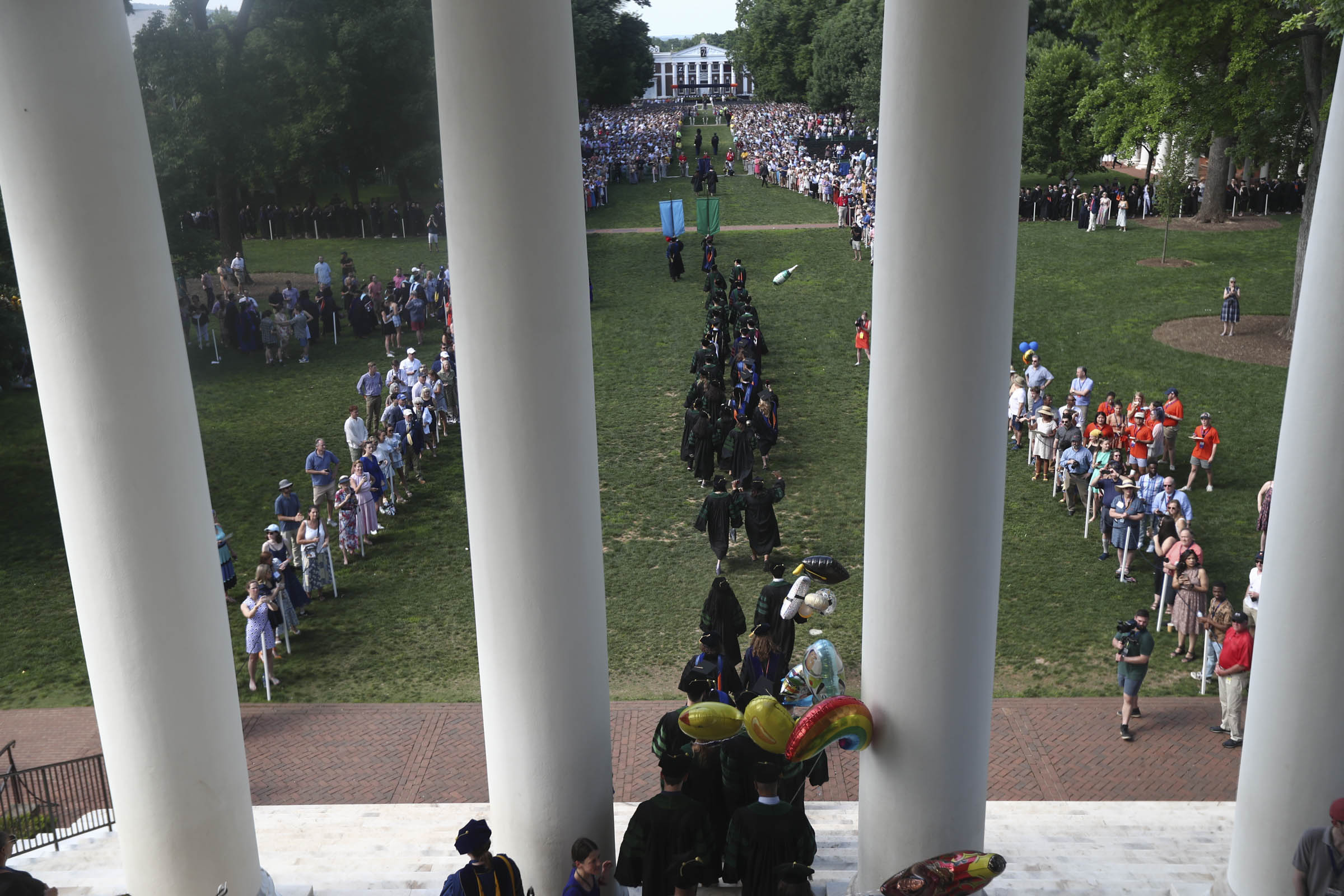 With Old Cabell Hall in the distance, students file from the top of the Rotunda’s steps, through its columns, and onto the Lawn.
