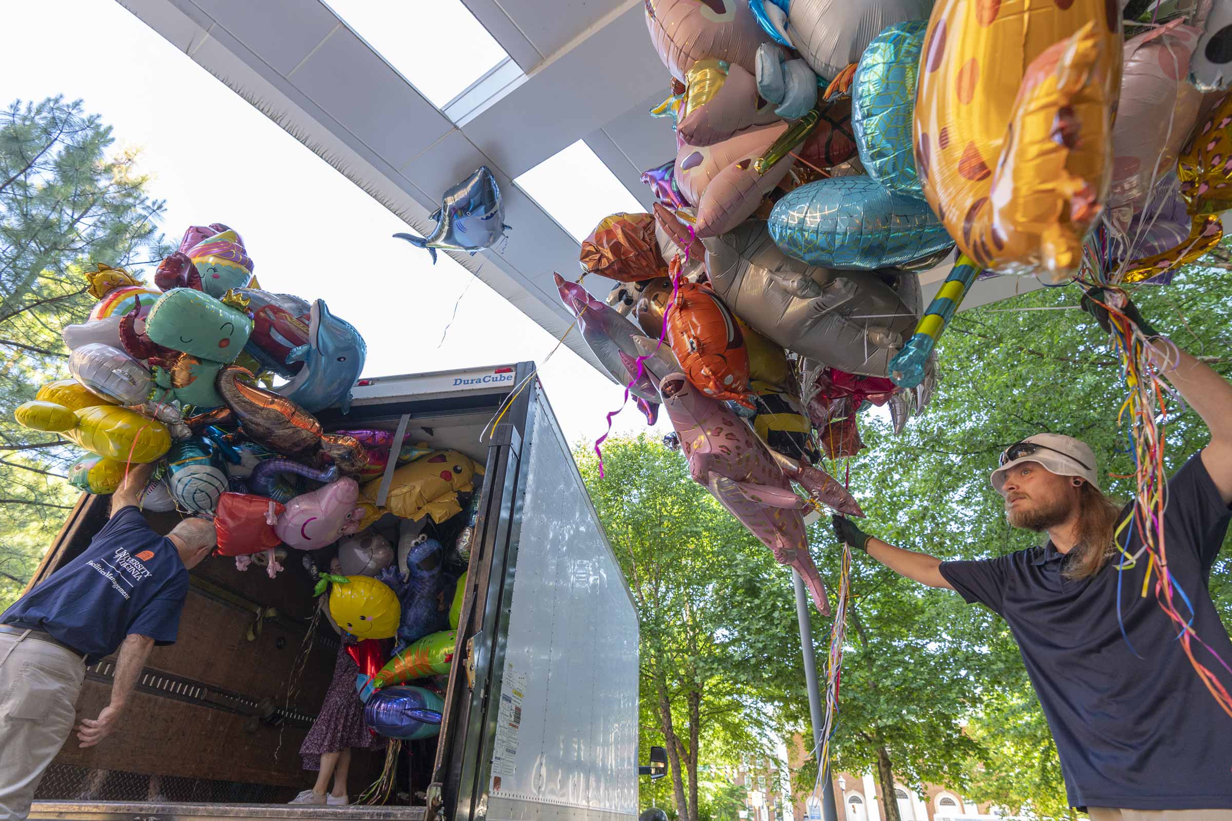 Facilities Management employees help deliver balloons to UVA Health Children’s. 