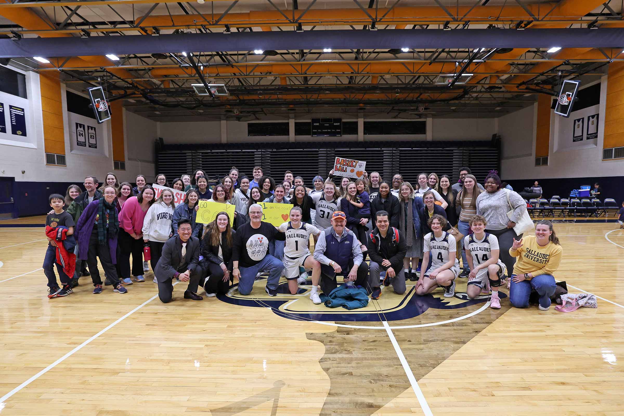 A large group of the ASL members gather for a photo on the court