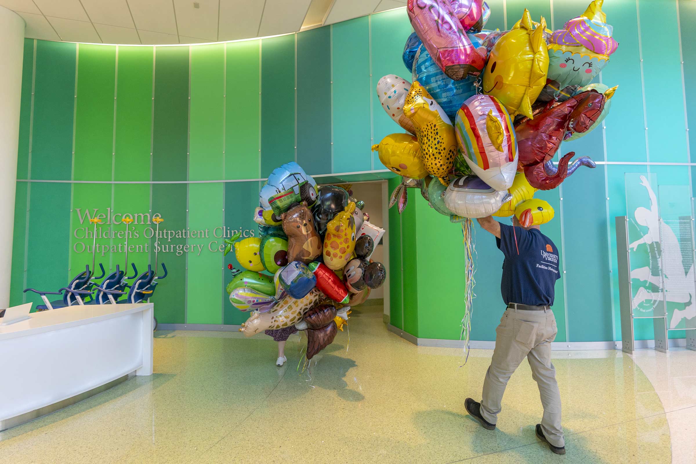 Workers carry the balloons into the brightly painted Battle Building. 