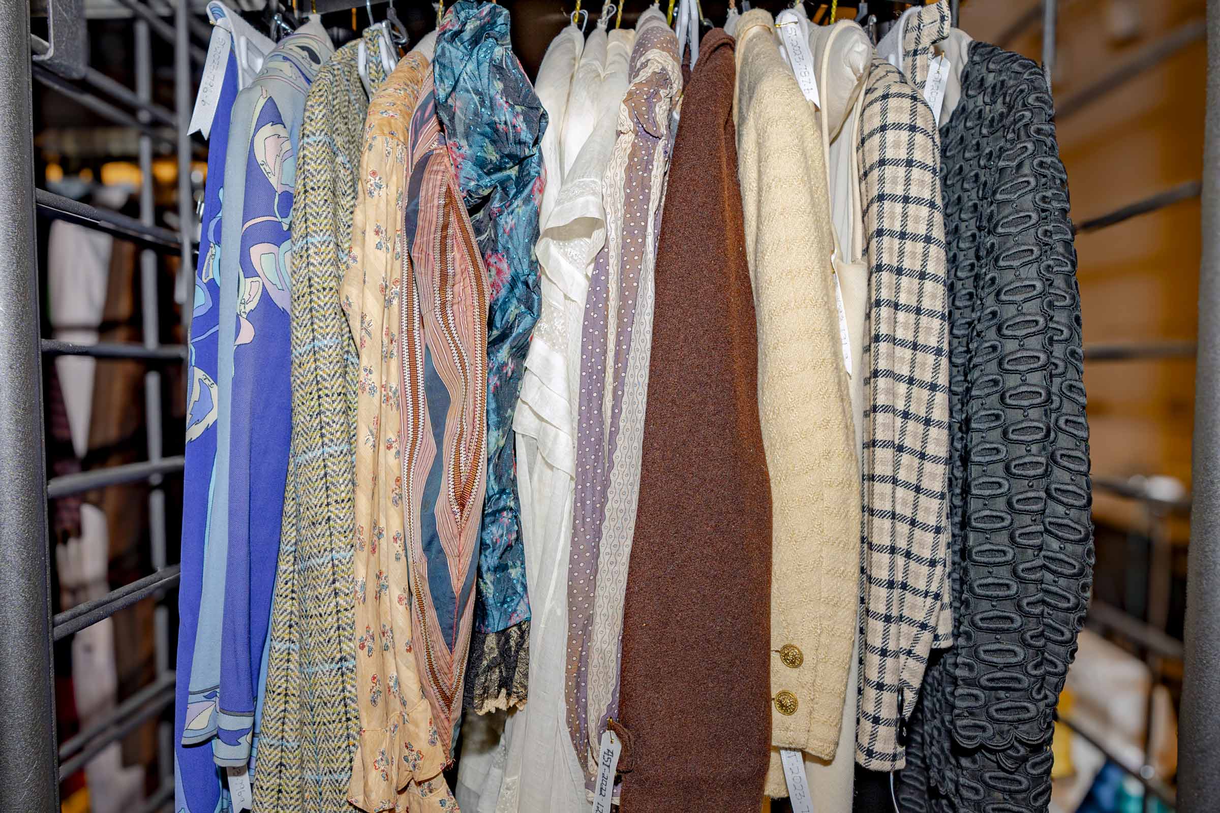 several articles of clothing hang together on a rack