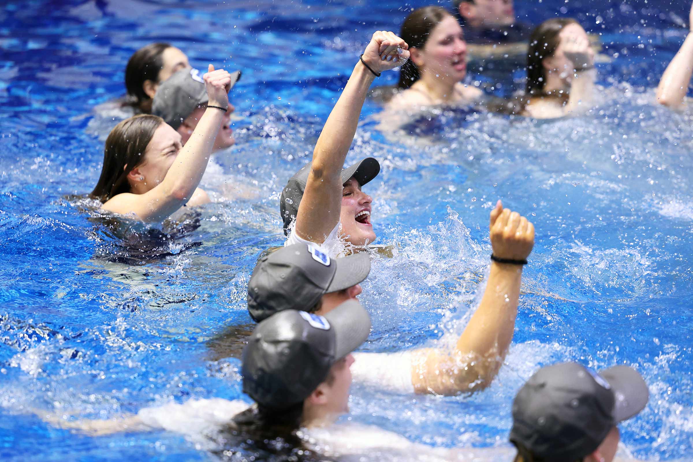swimmers celebrate in the pool