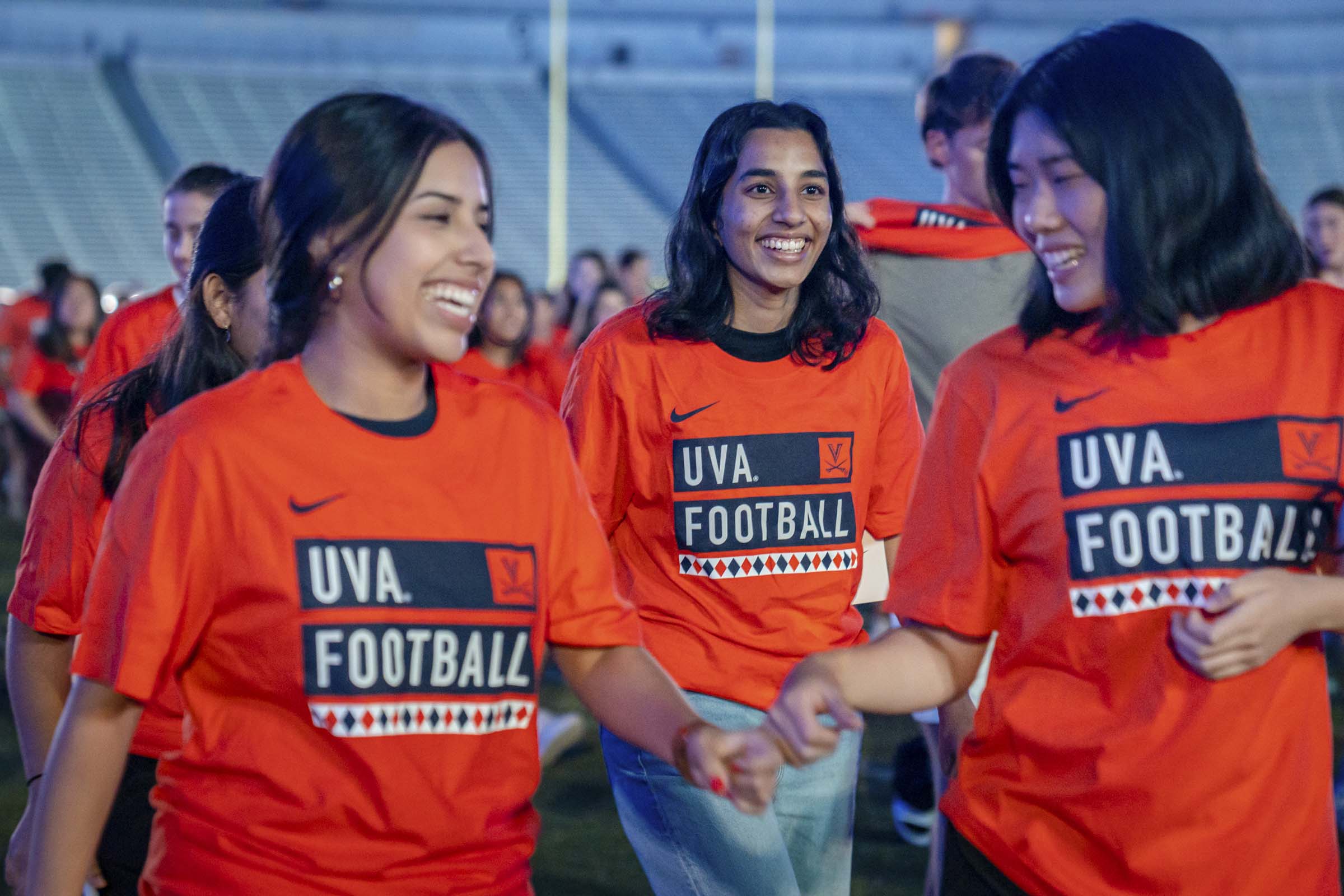 Students smiling with UVA Football shirts on