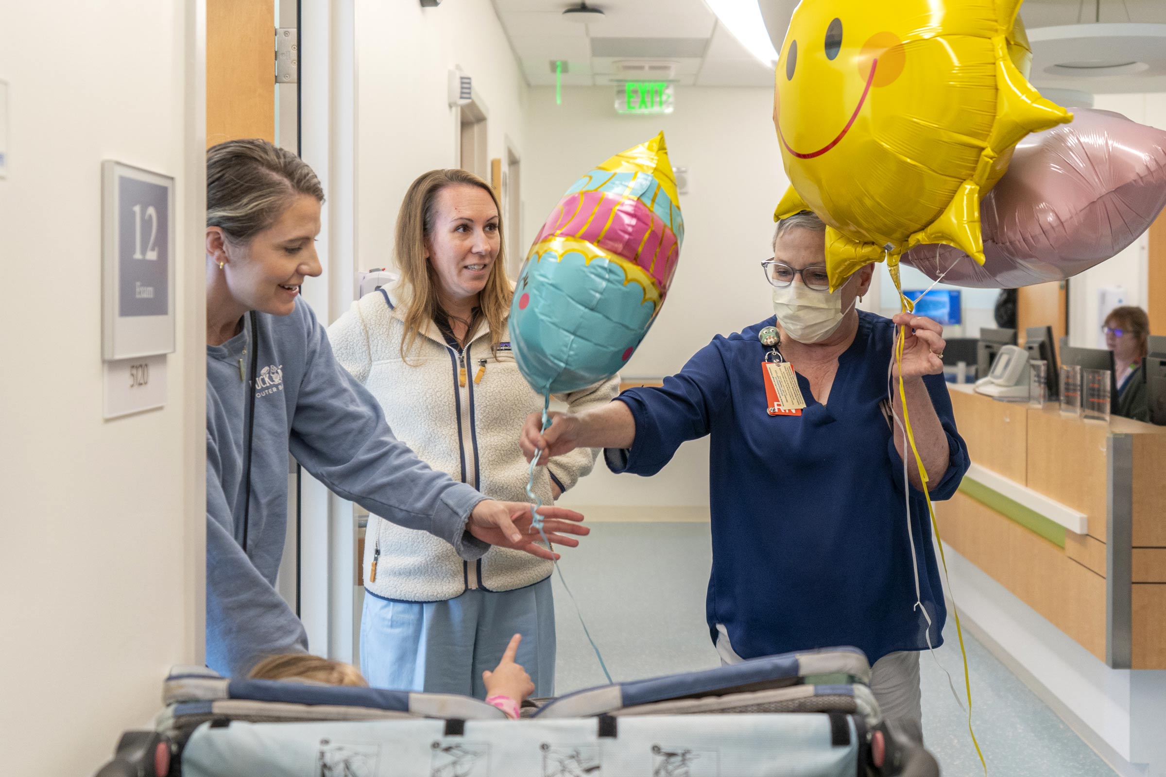 Registered nurse Christina Knicely helps give out balloons. 