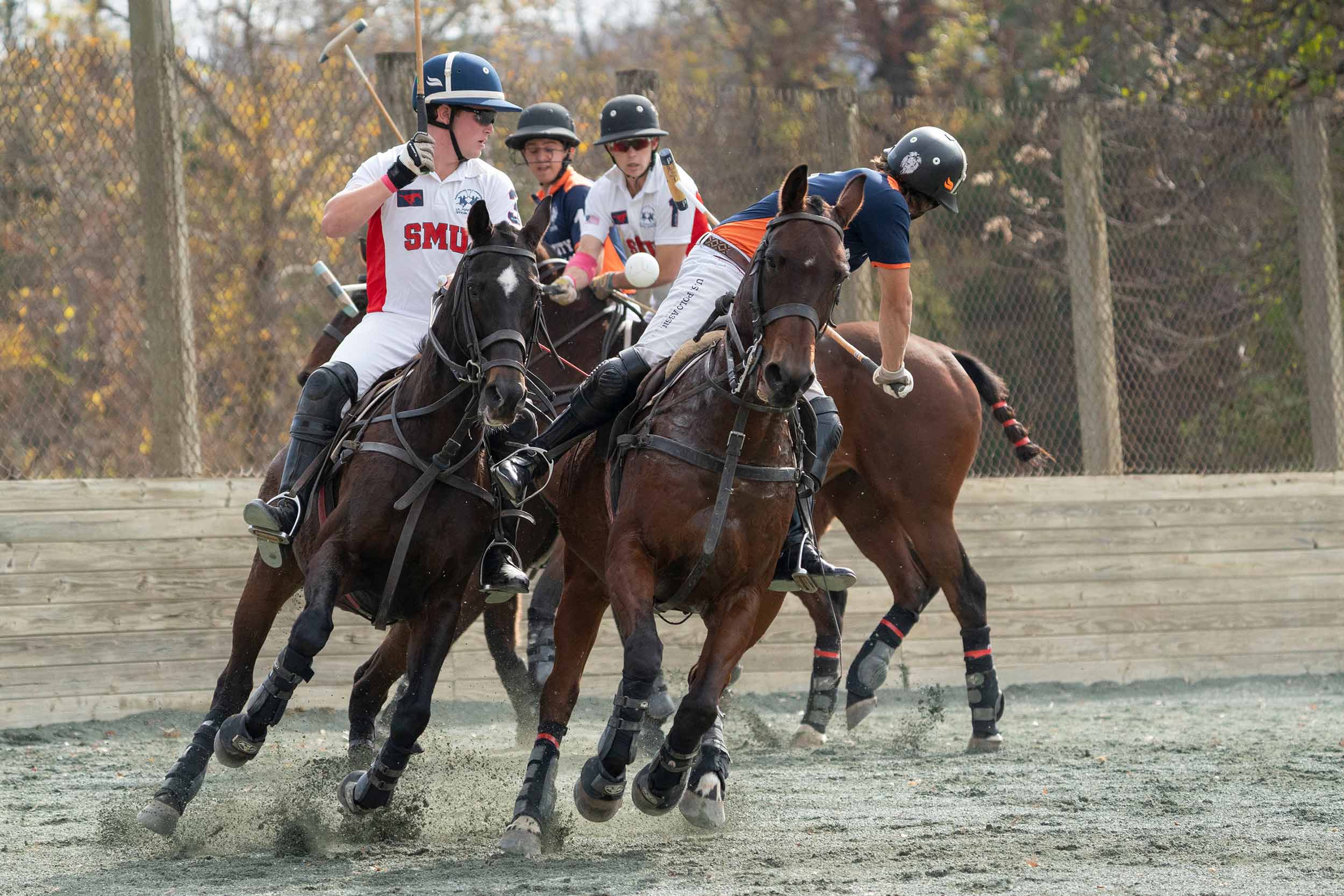 four horses and polo players going after a ball