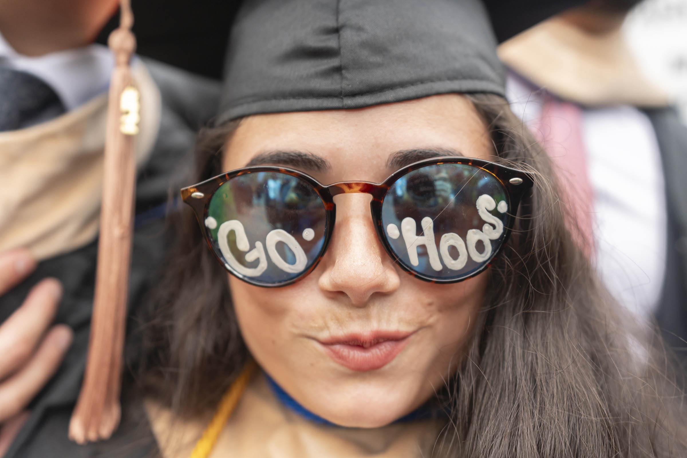 A student wears glasses with "Go Hoos" written on the lenses