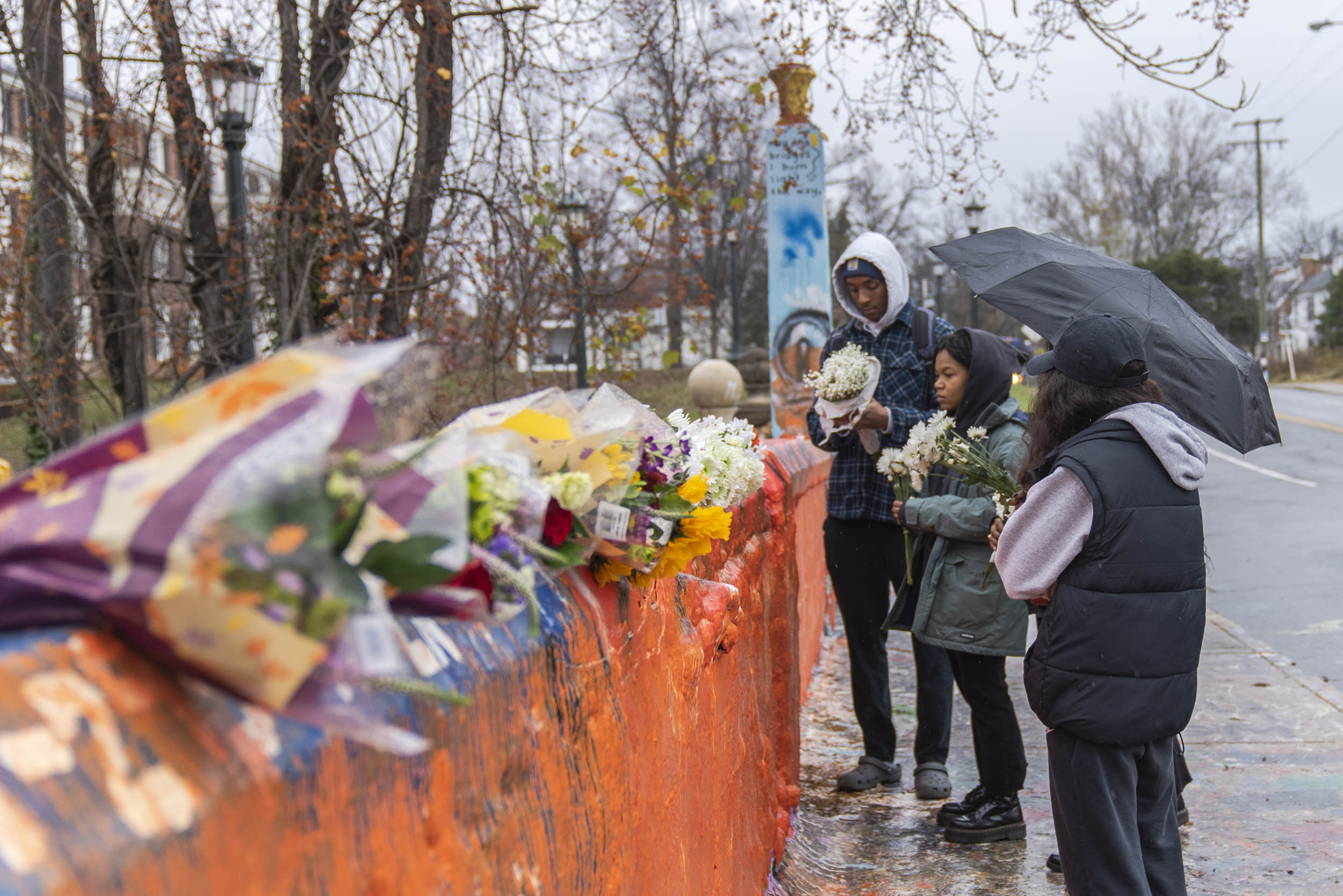 Students visiting Beta Bridge, placing flowers
