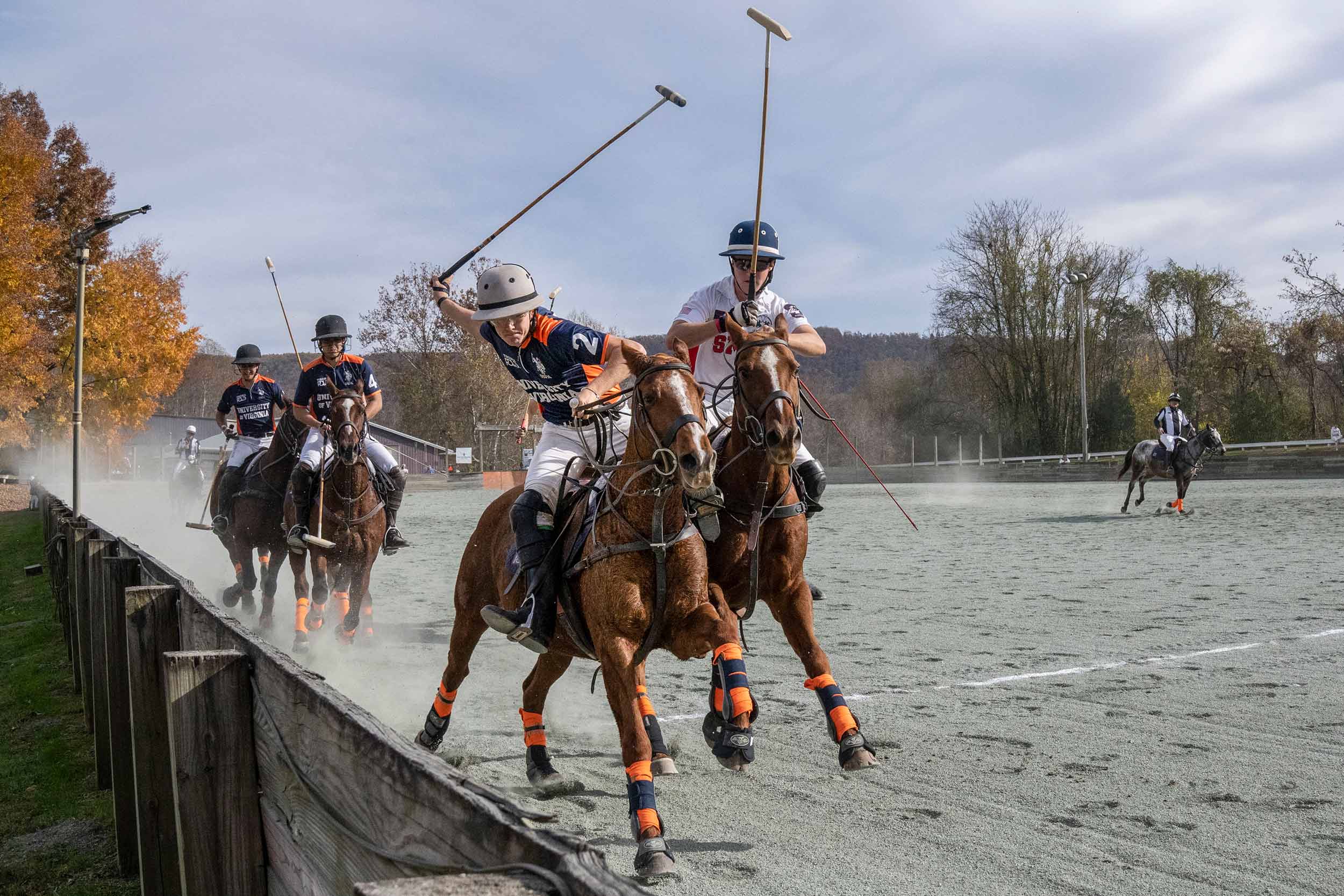 UVA polo player during a matching swinging to hit the ball