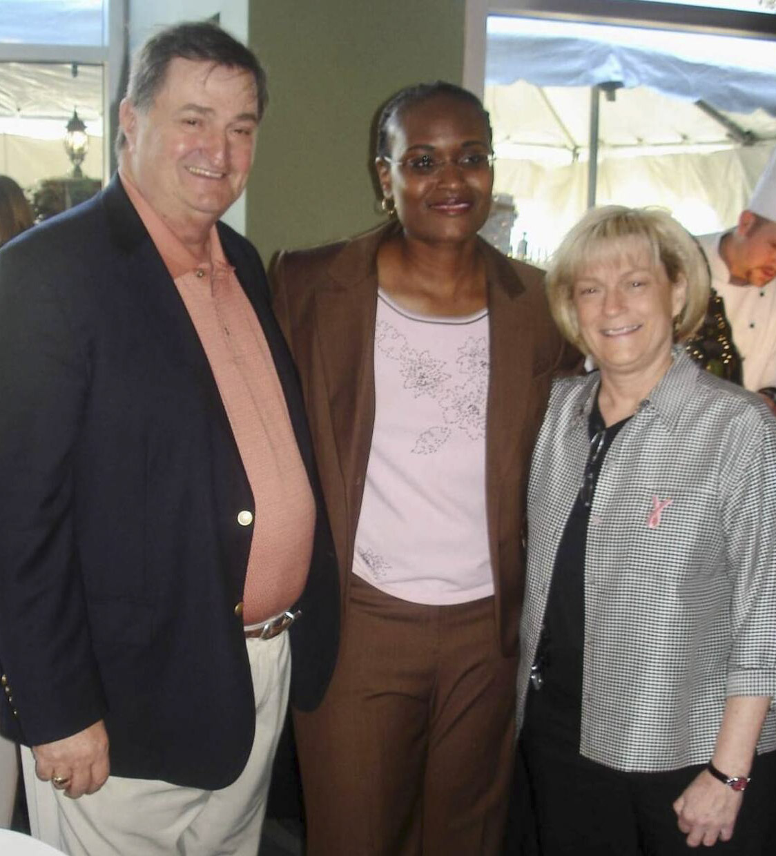 Grimes-Miller, center, with Ralph McGirk, her high school coach, and UVA coaching legend Debbie Ryan