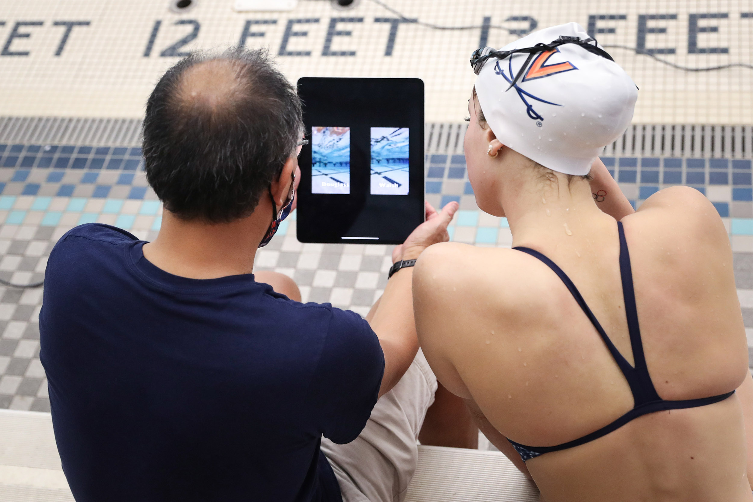coach and swimmer watching video of their swim