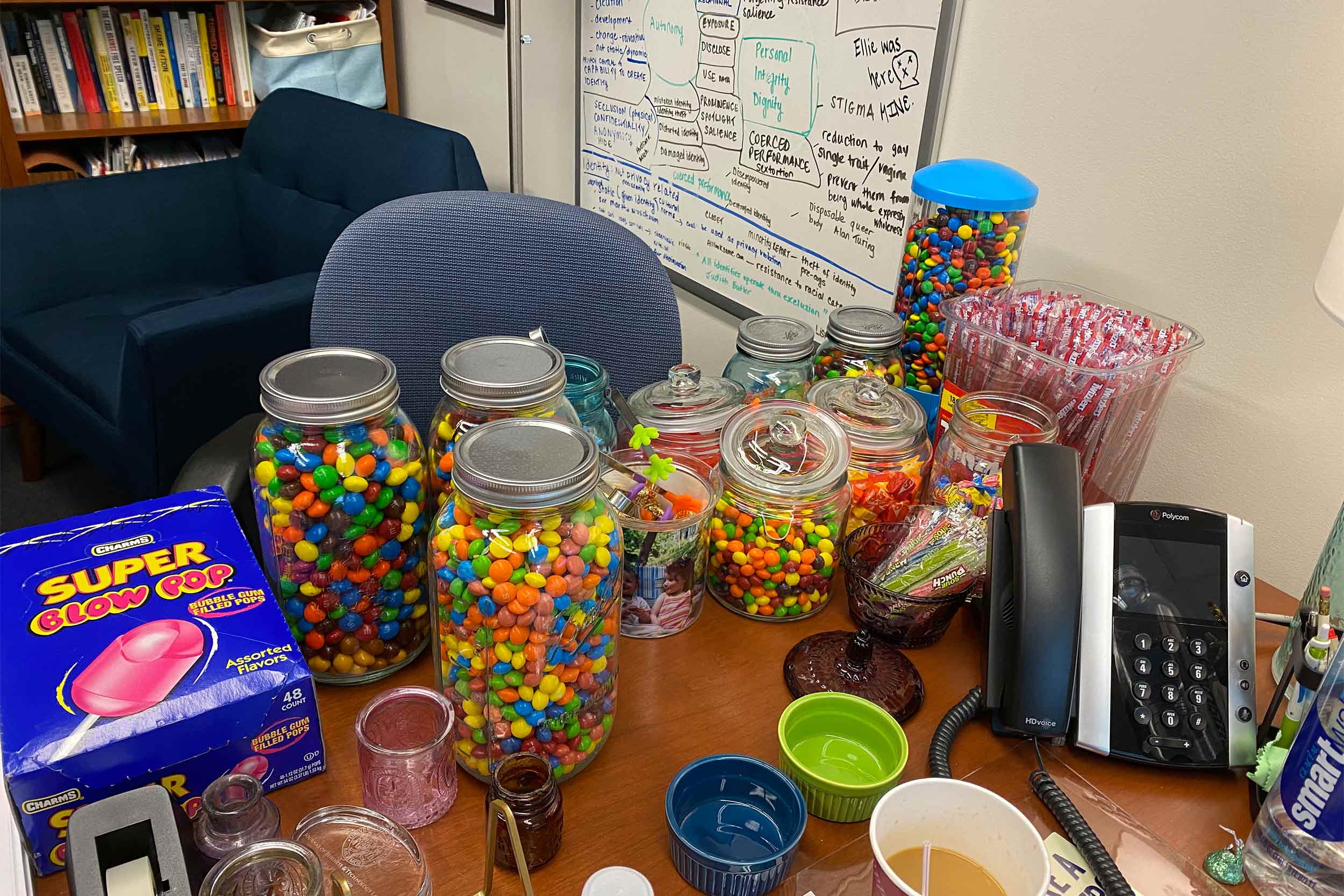 A desk covered in jars of candy