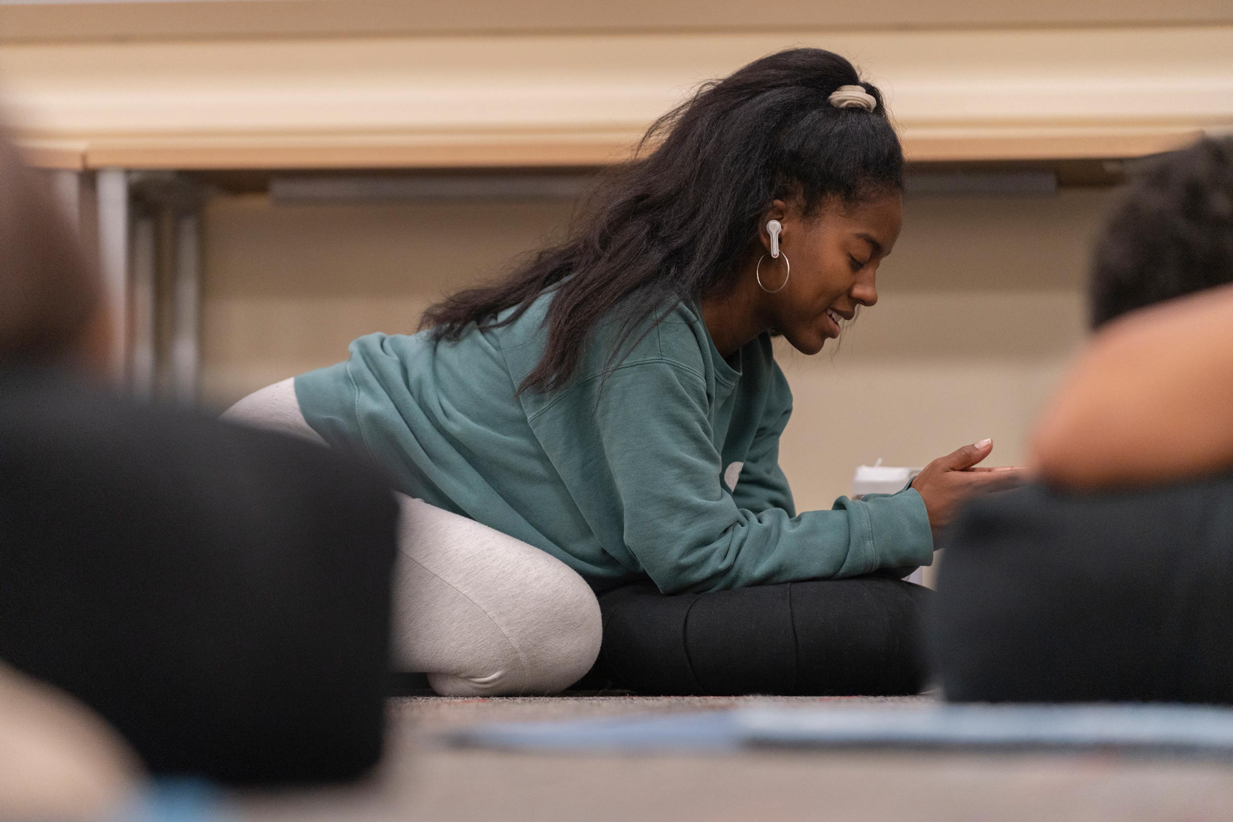 Carrington Kernodle Epperson on her knees bent forward in a yoga pose meditating