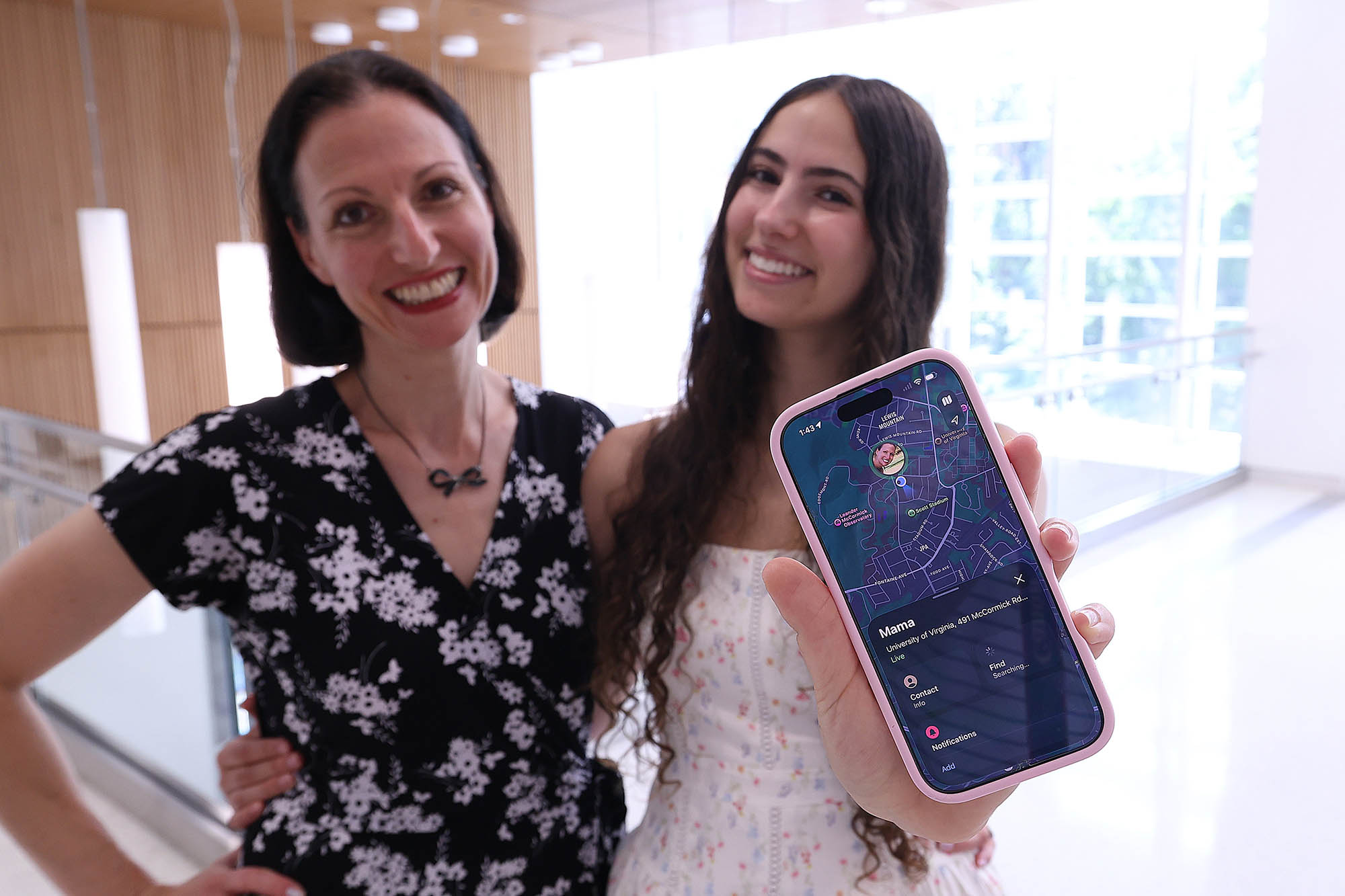 Bethany and Haven Teachman posing together with phone in foreground.