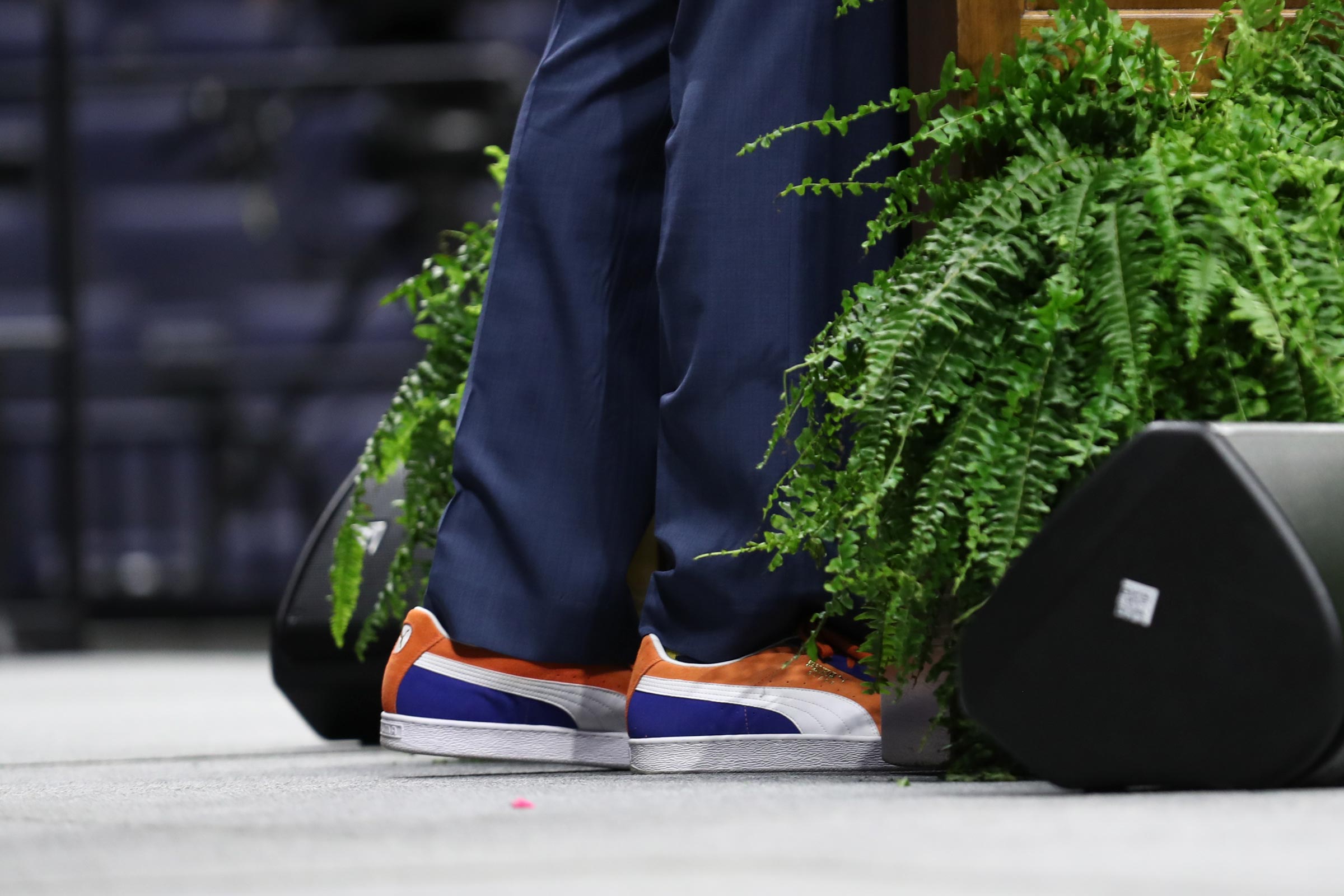 Ralph Sampson's orange, white and blue sneakers behind the podium