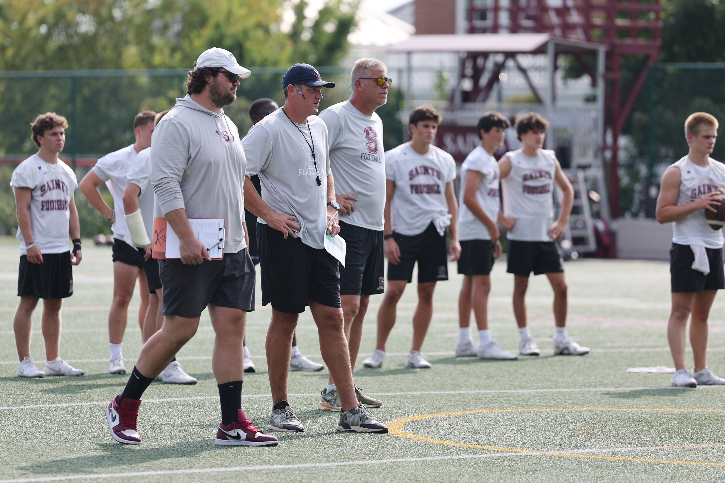 Candid portrait of UVA football alumni Austin Pasztor, left, and Chris Luzar, right with other football player.