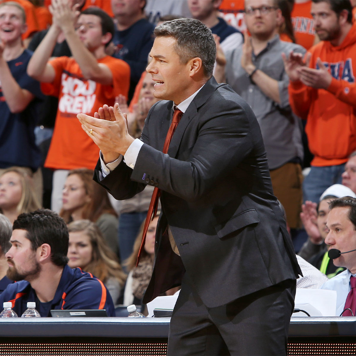 Tony Bennett court side cheering on the team during a game.