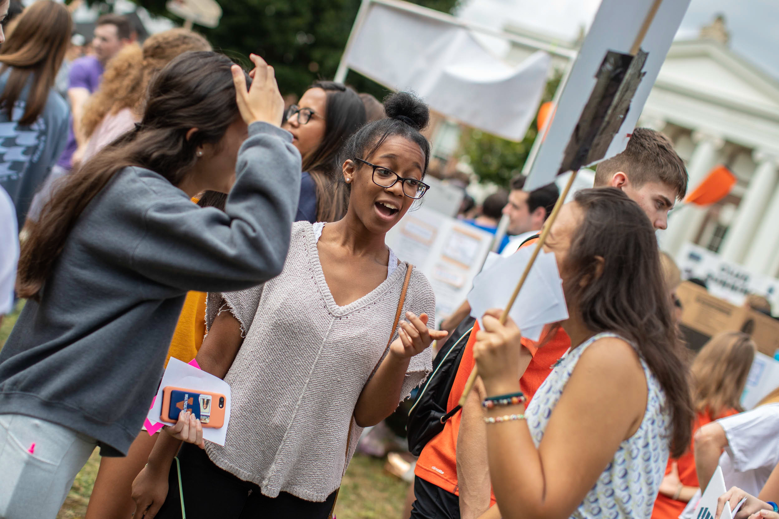 Students talking at the activities fair on the Lawn