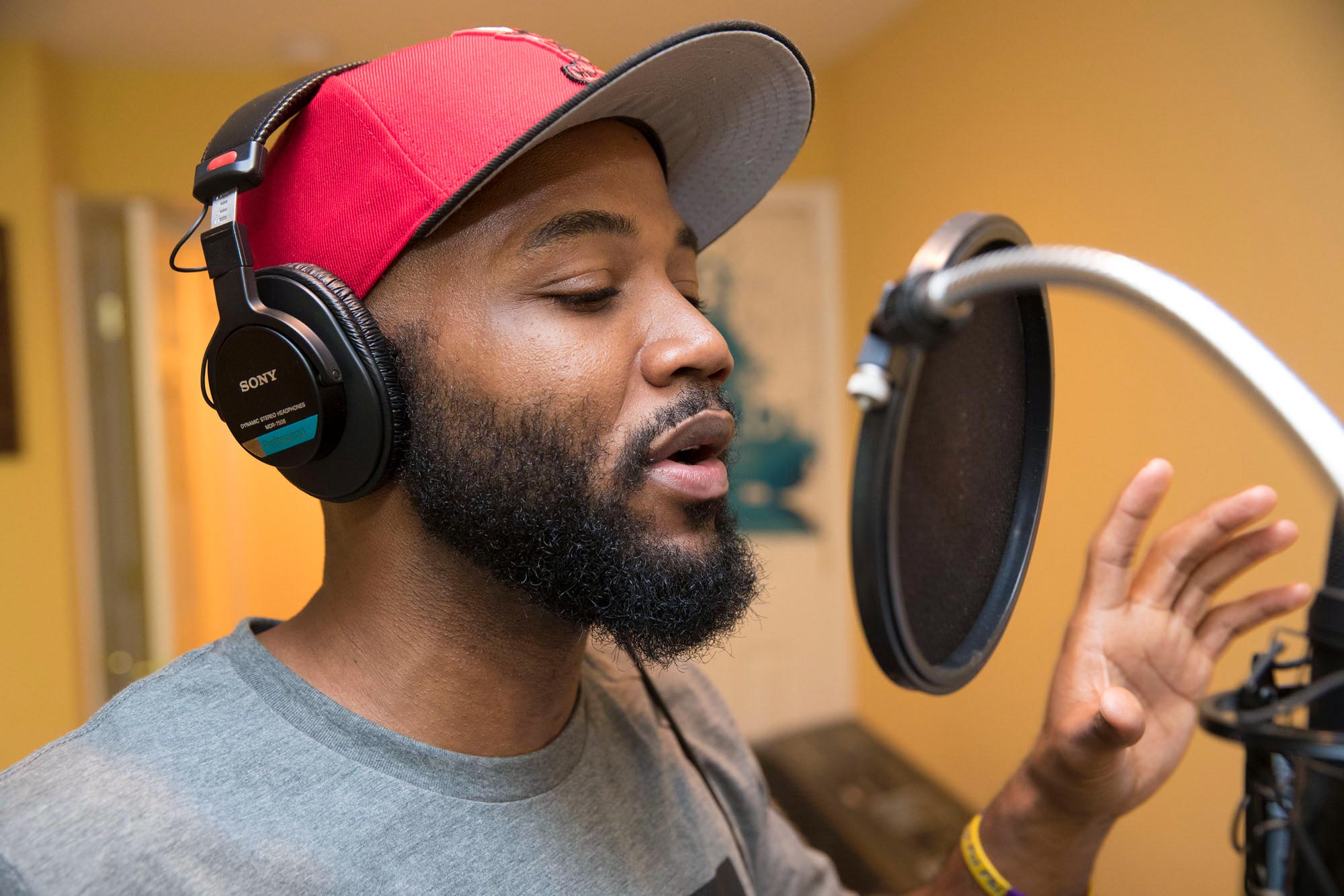 Carson rehearsing in his home studio into a microphone