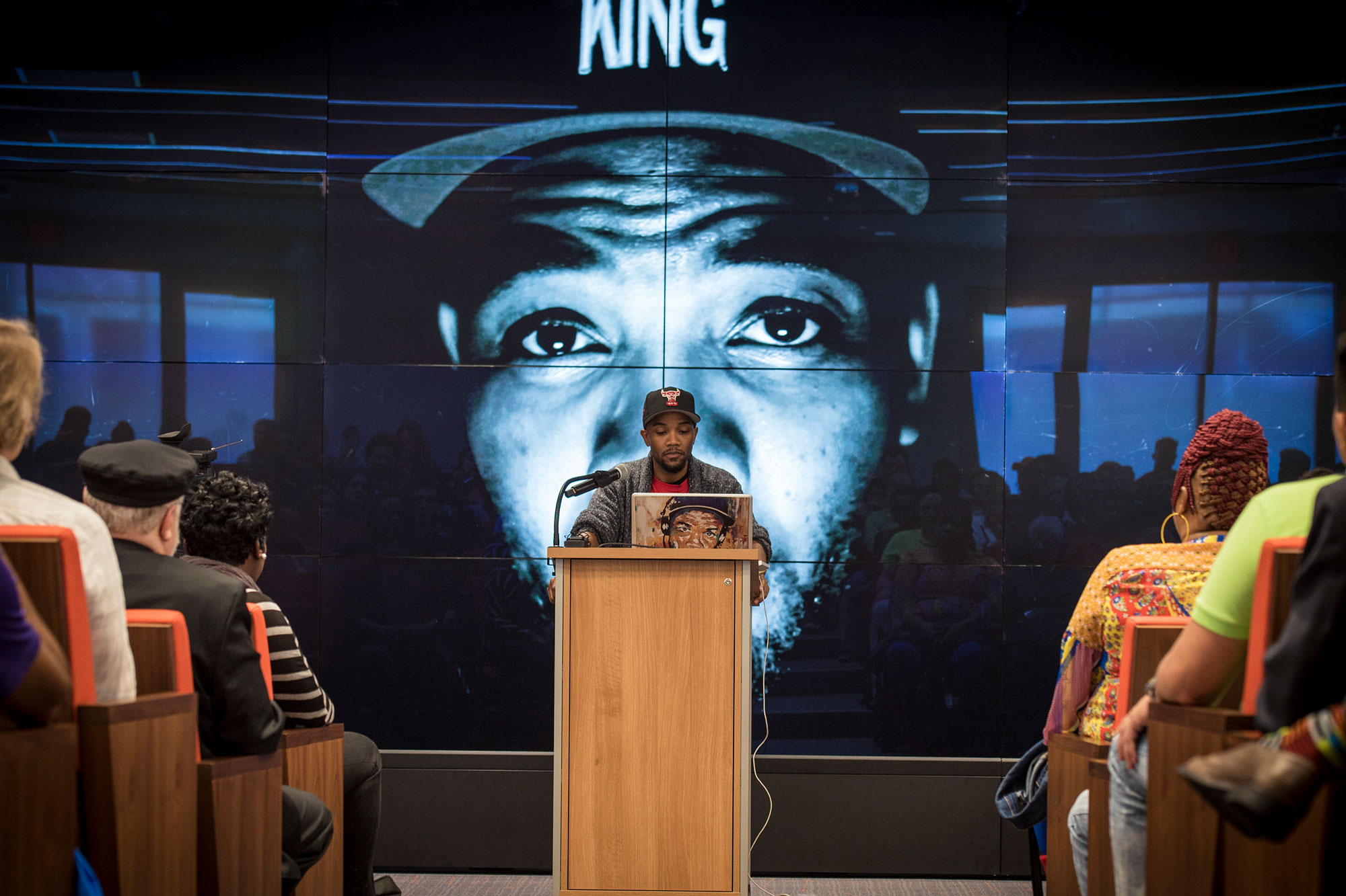 Carson standing at a podium talking to a group of people