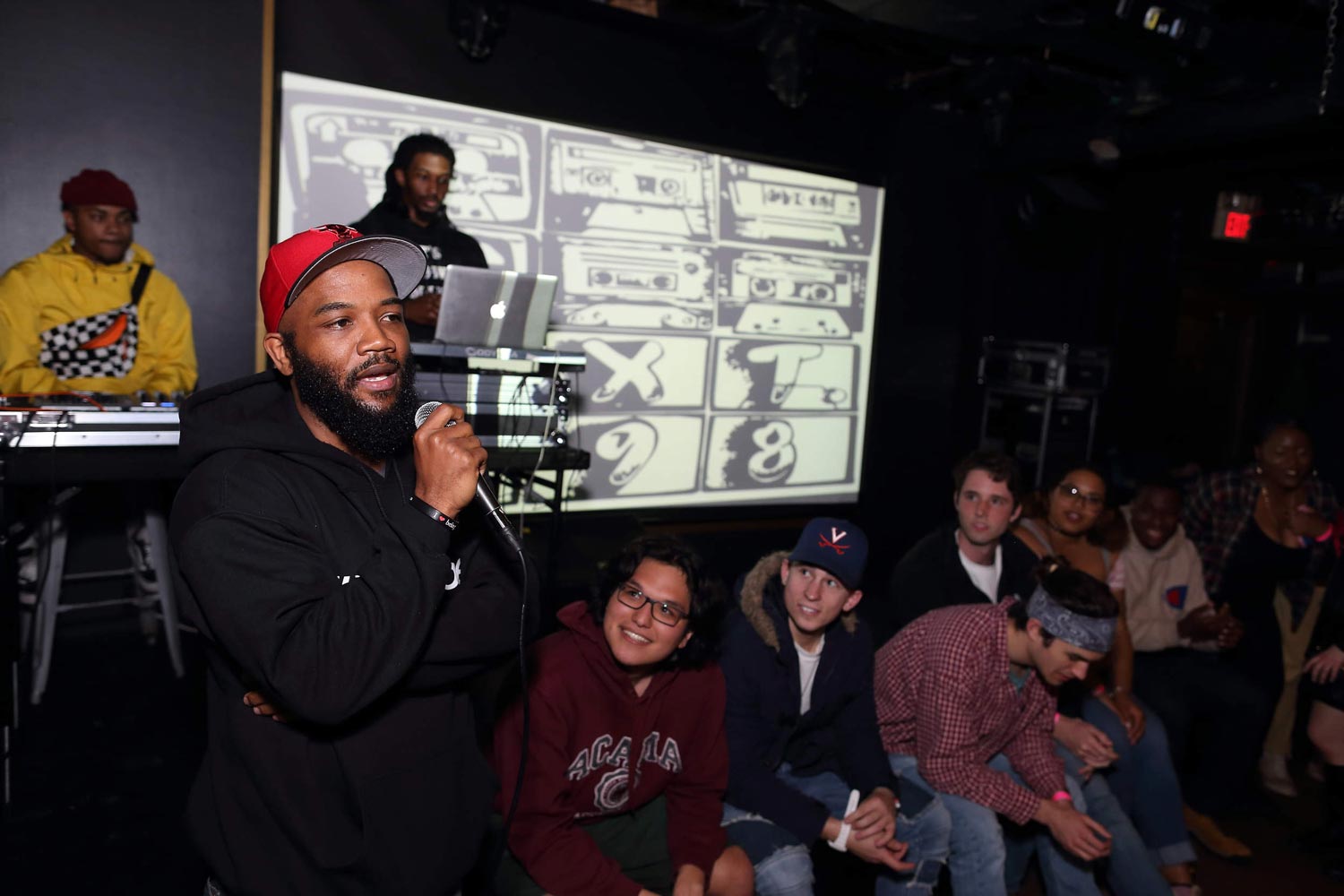 Carson speaking to a crowd in a bar