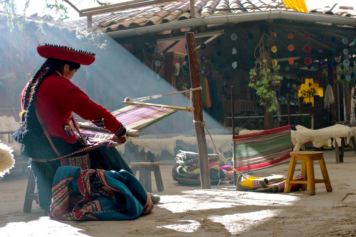 Woman from an Andean village weaving in her home