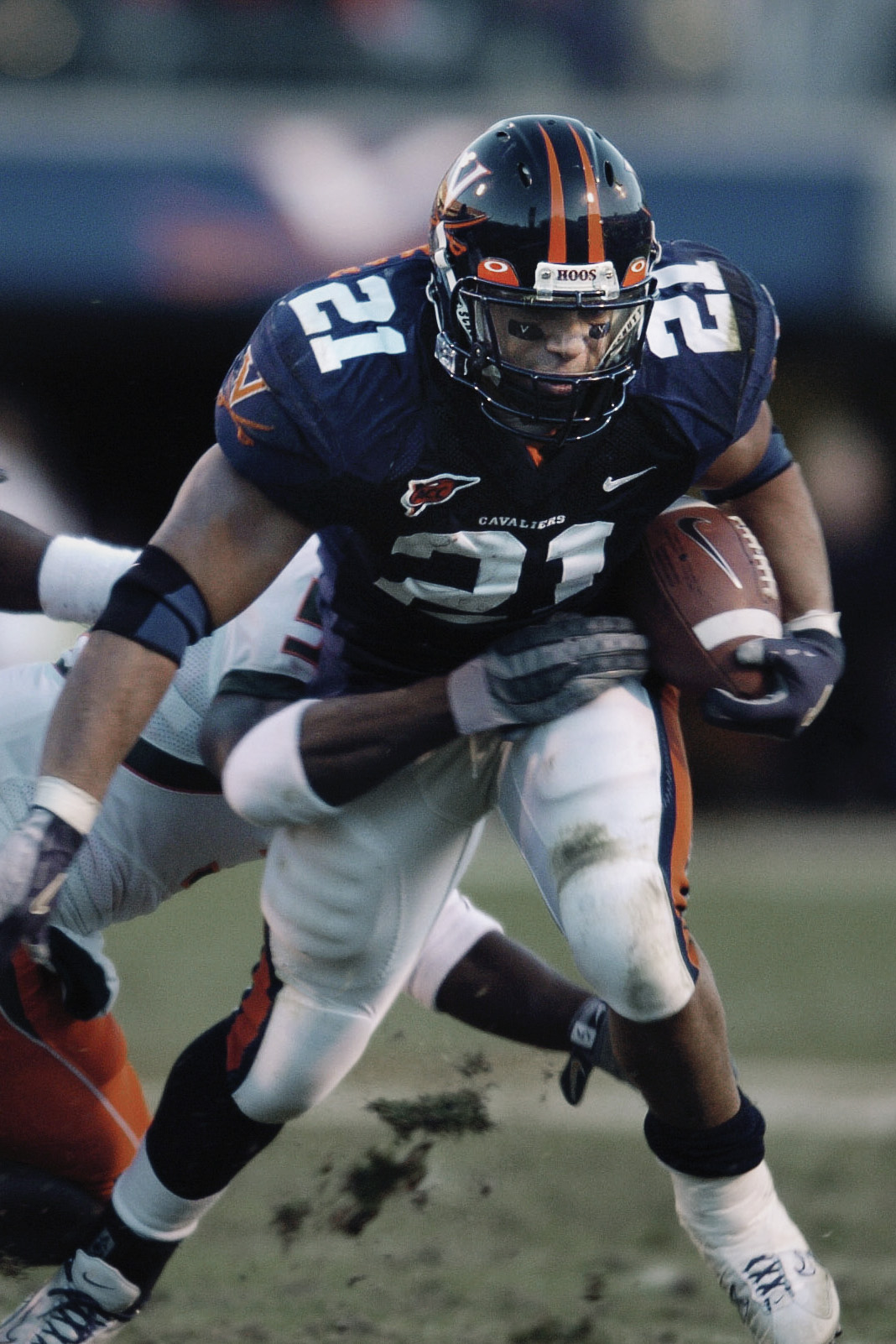 Pearman running with the ball as an opponent tries to tackle him