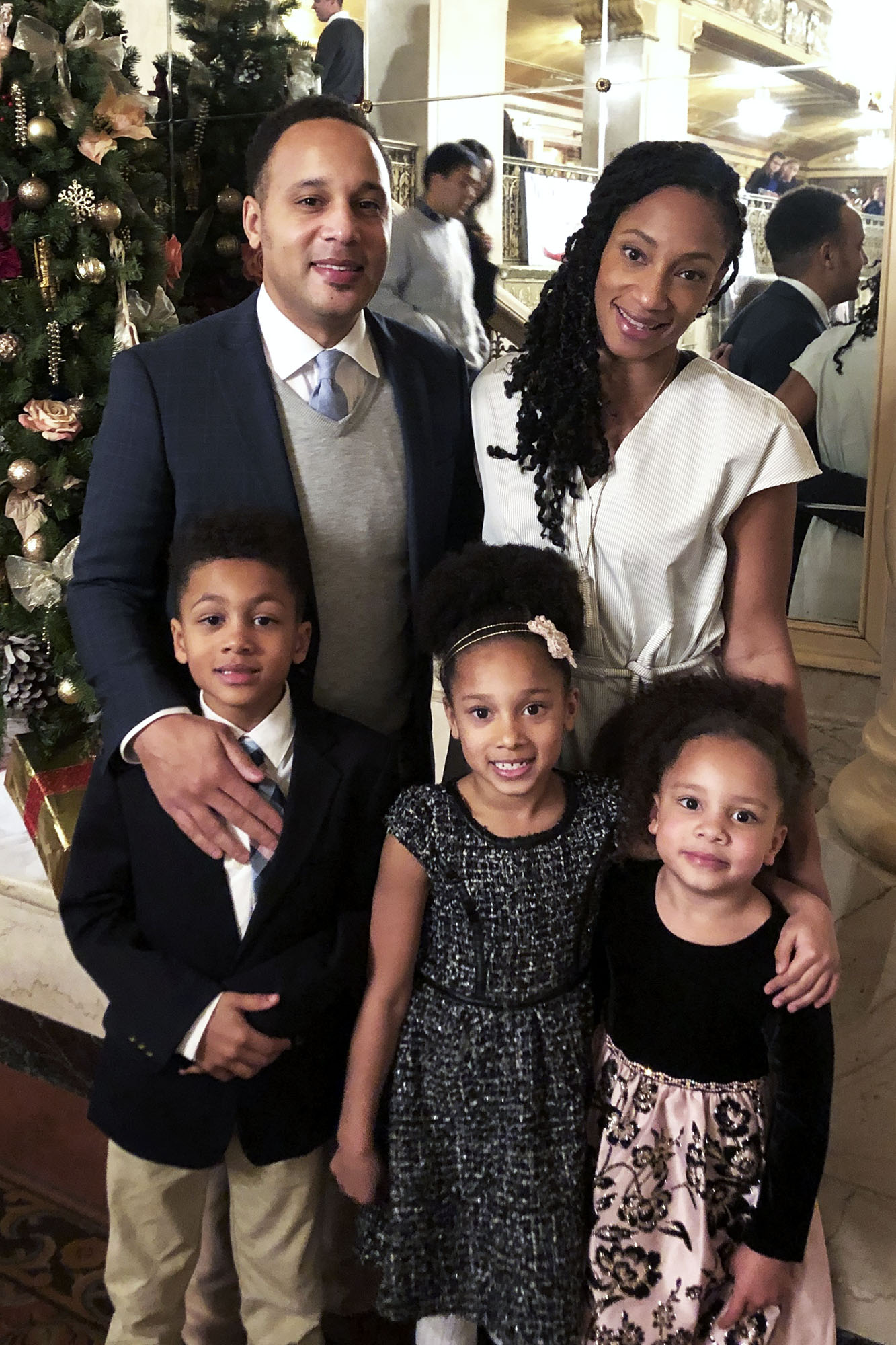 Pearman and his wife, Kristin, and their three children standing for a holiday photo