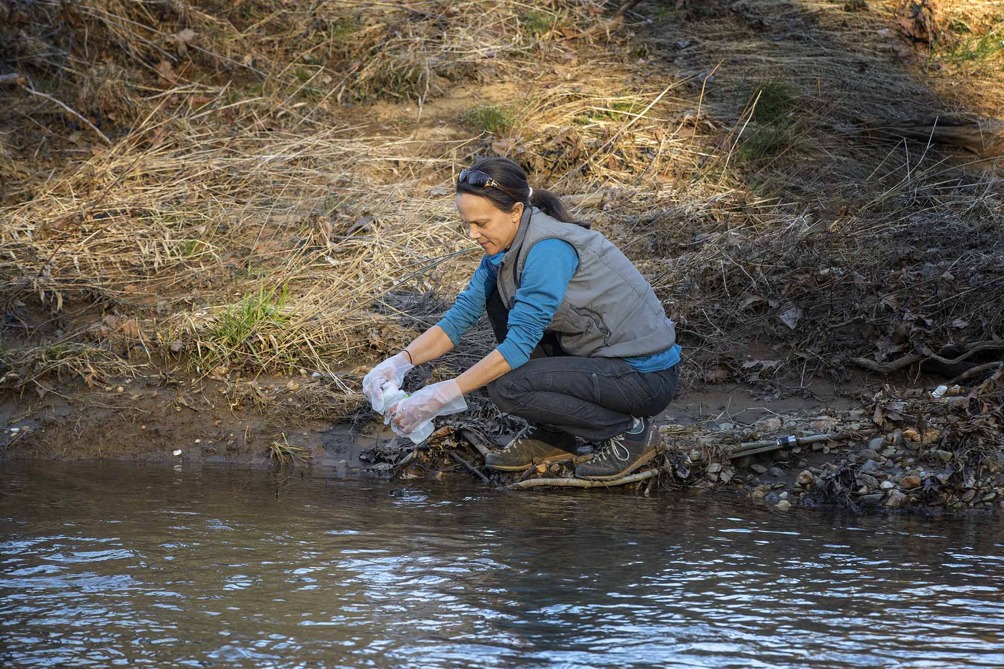 Ami Riscassi collecting a water sample in the national park