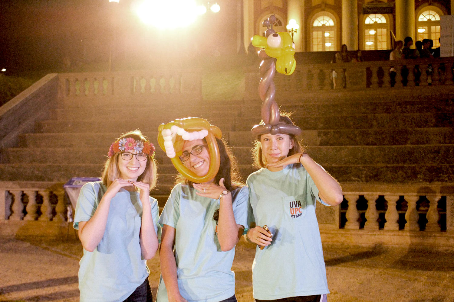 Students wearing ballon art smile for the camera